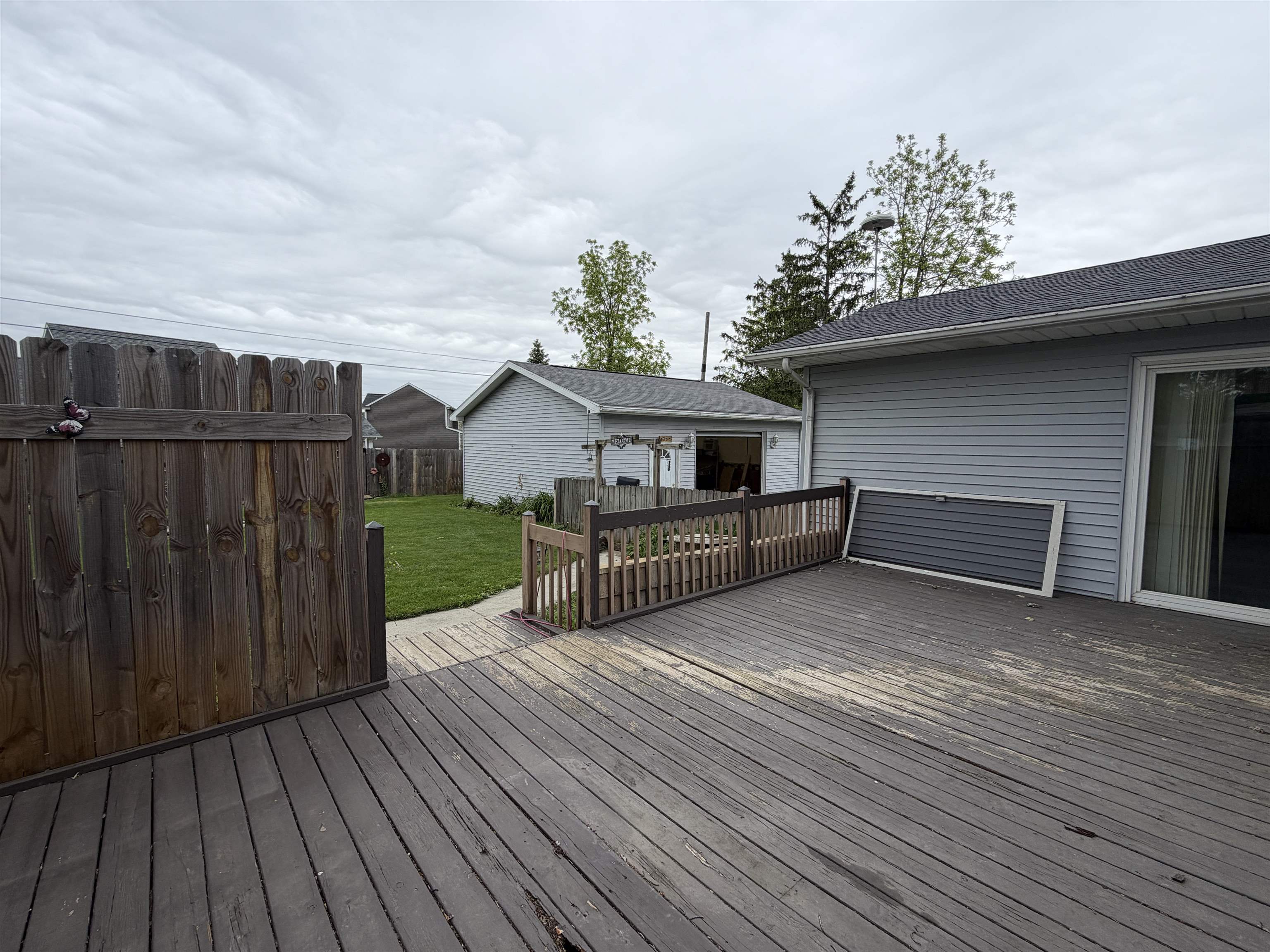 Spacious wood-finish deck with a wood privacy fence and railing