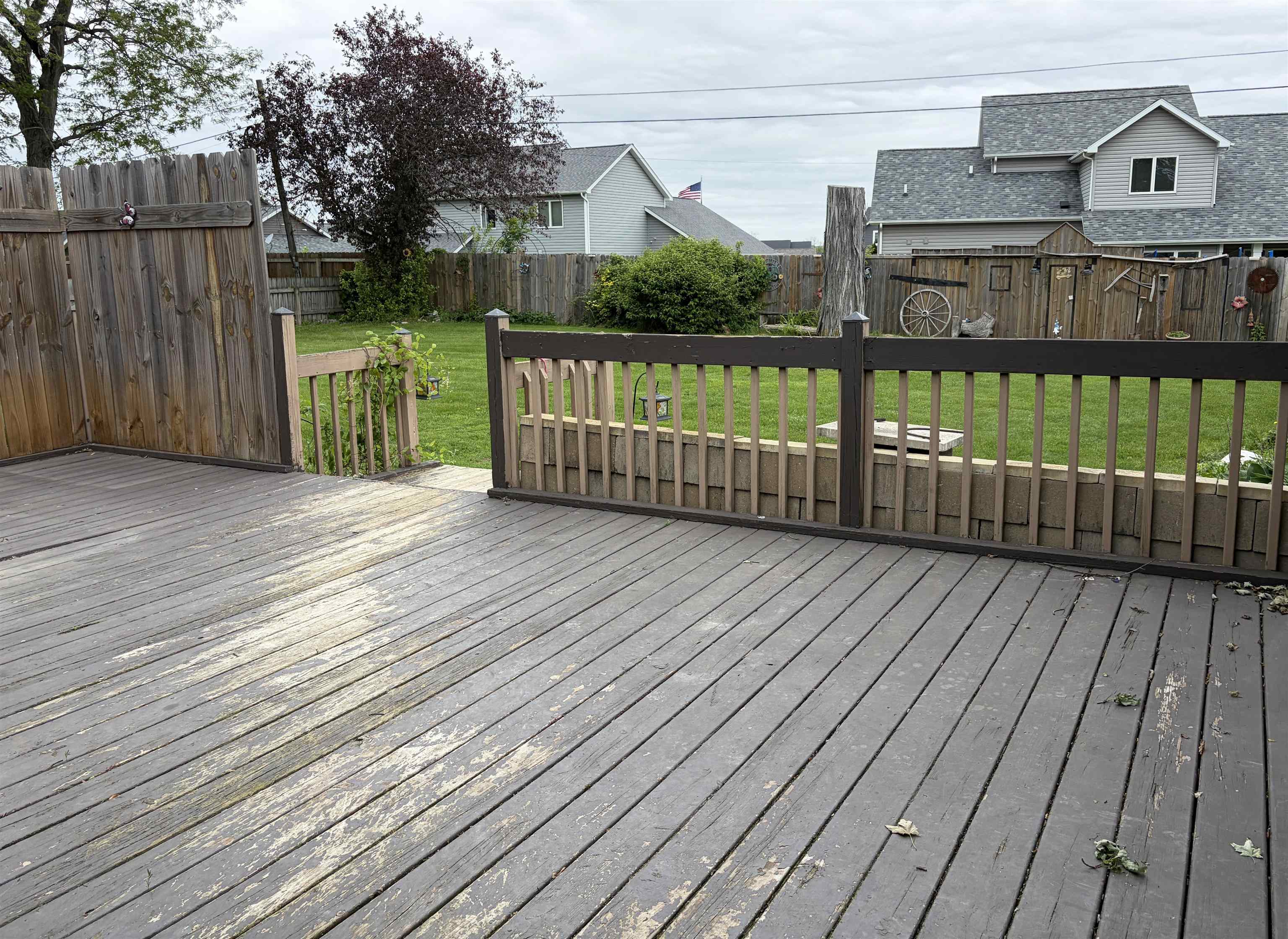 Spacious outdoor deck with wood flooring and a perimeter railing