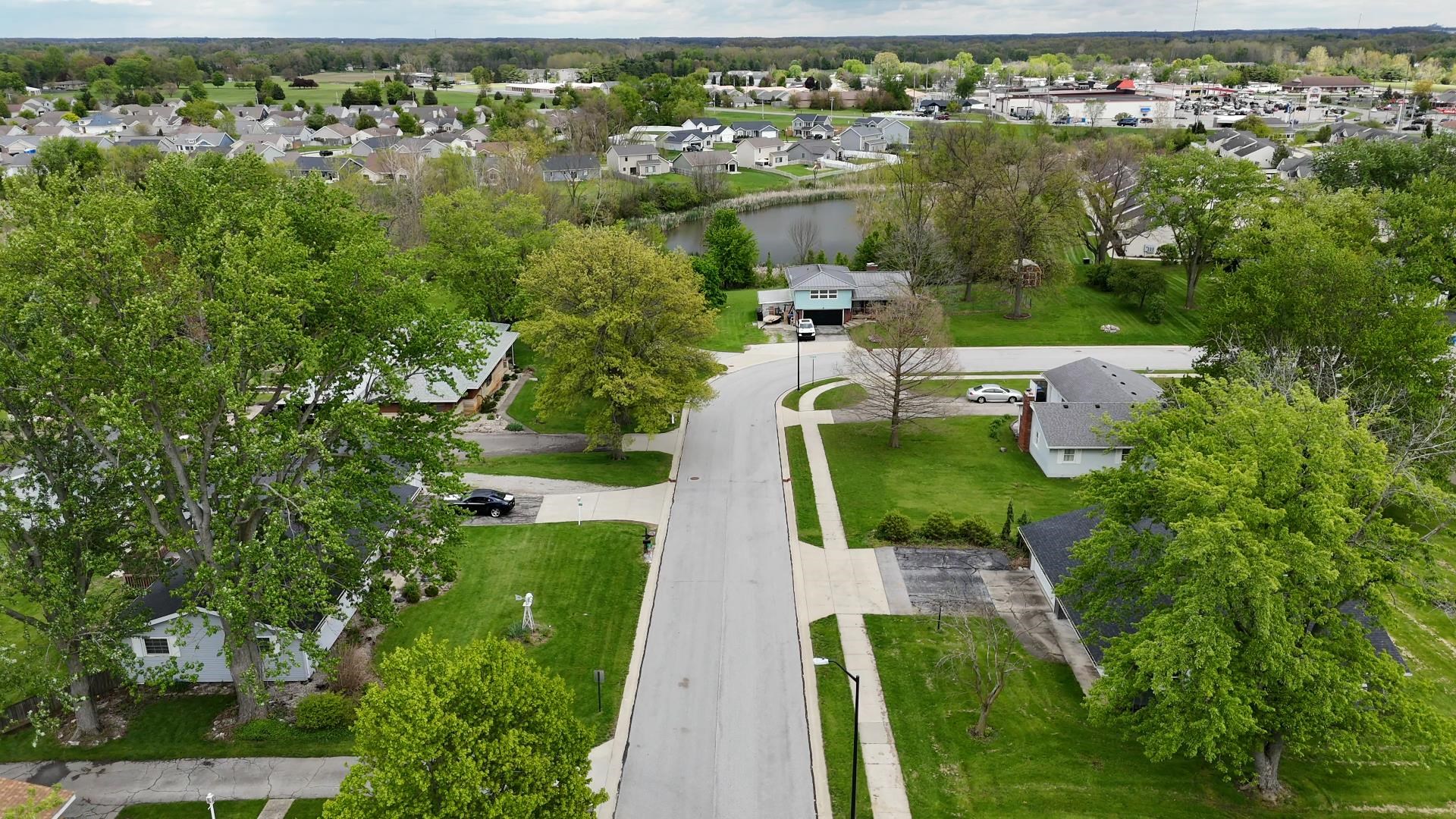 Residential street with mature trees and maintained lawns