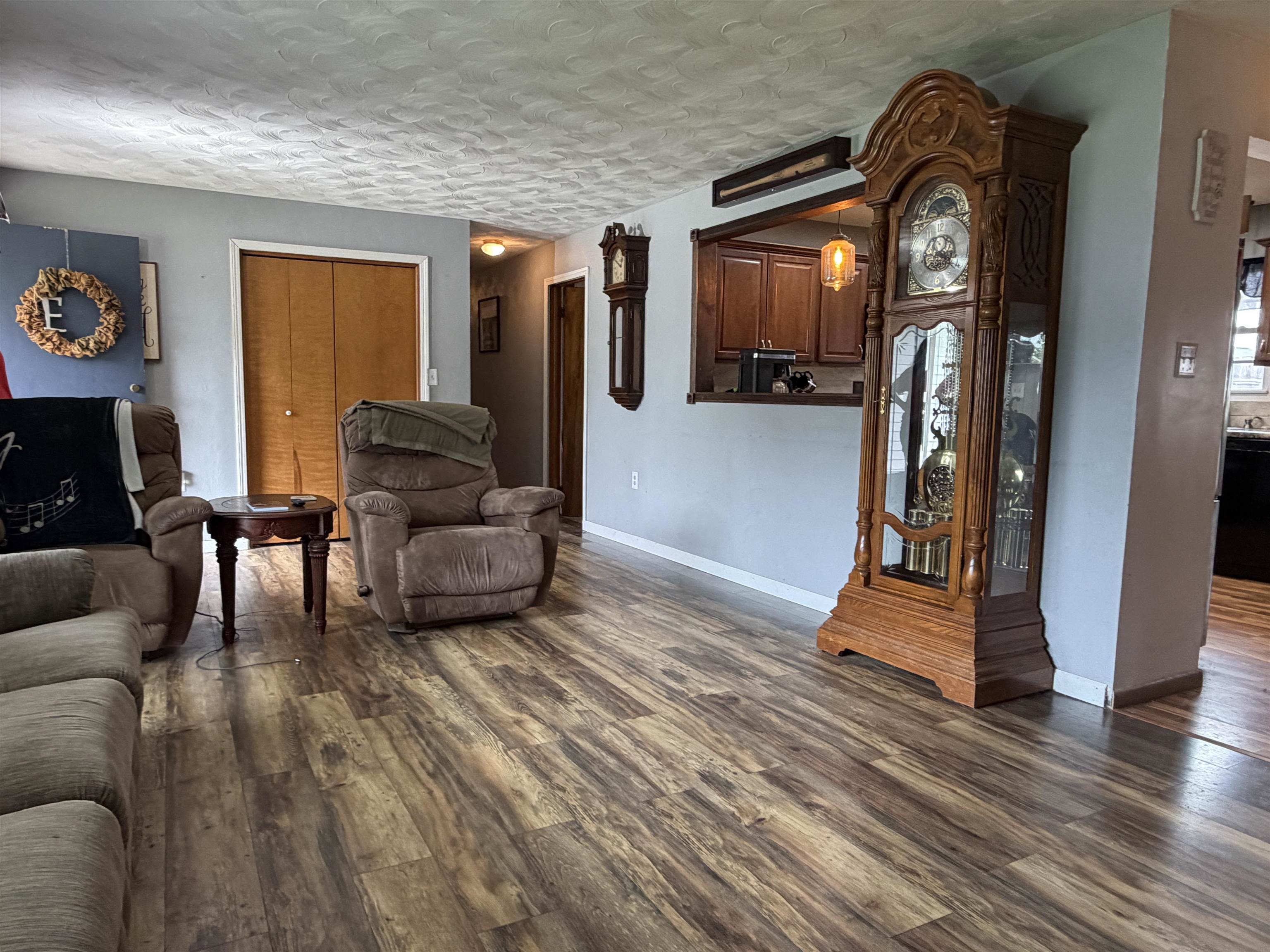 Living area featuring wood-finish flooring and light gray walls