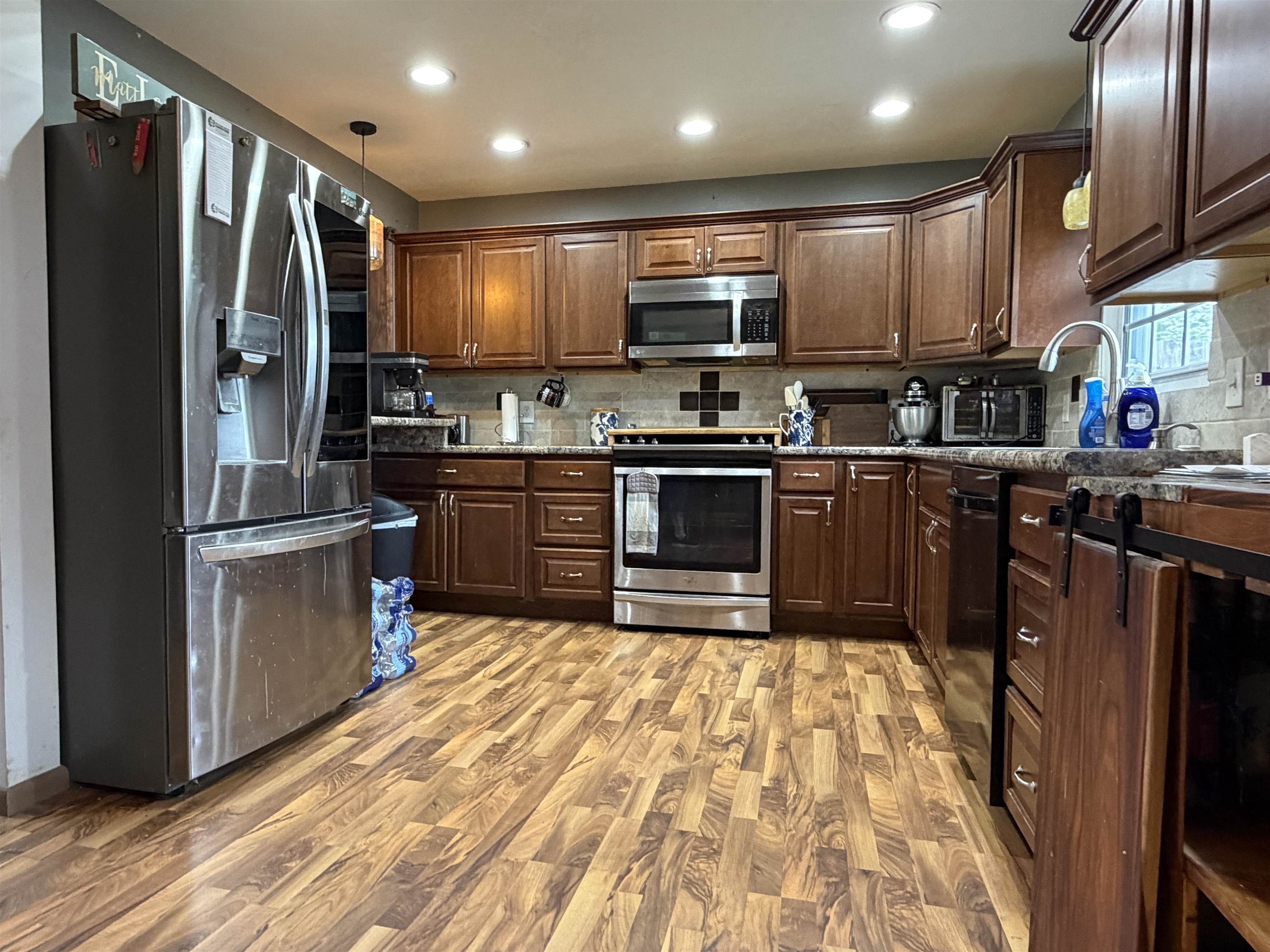 Kitchen featuring wood-finish flooring, recessed lighting, and rich wood cabinetry