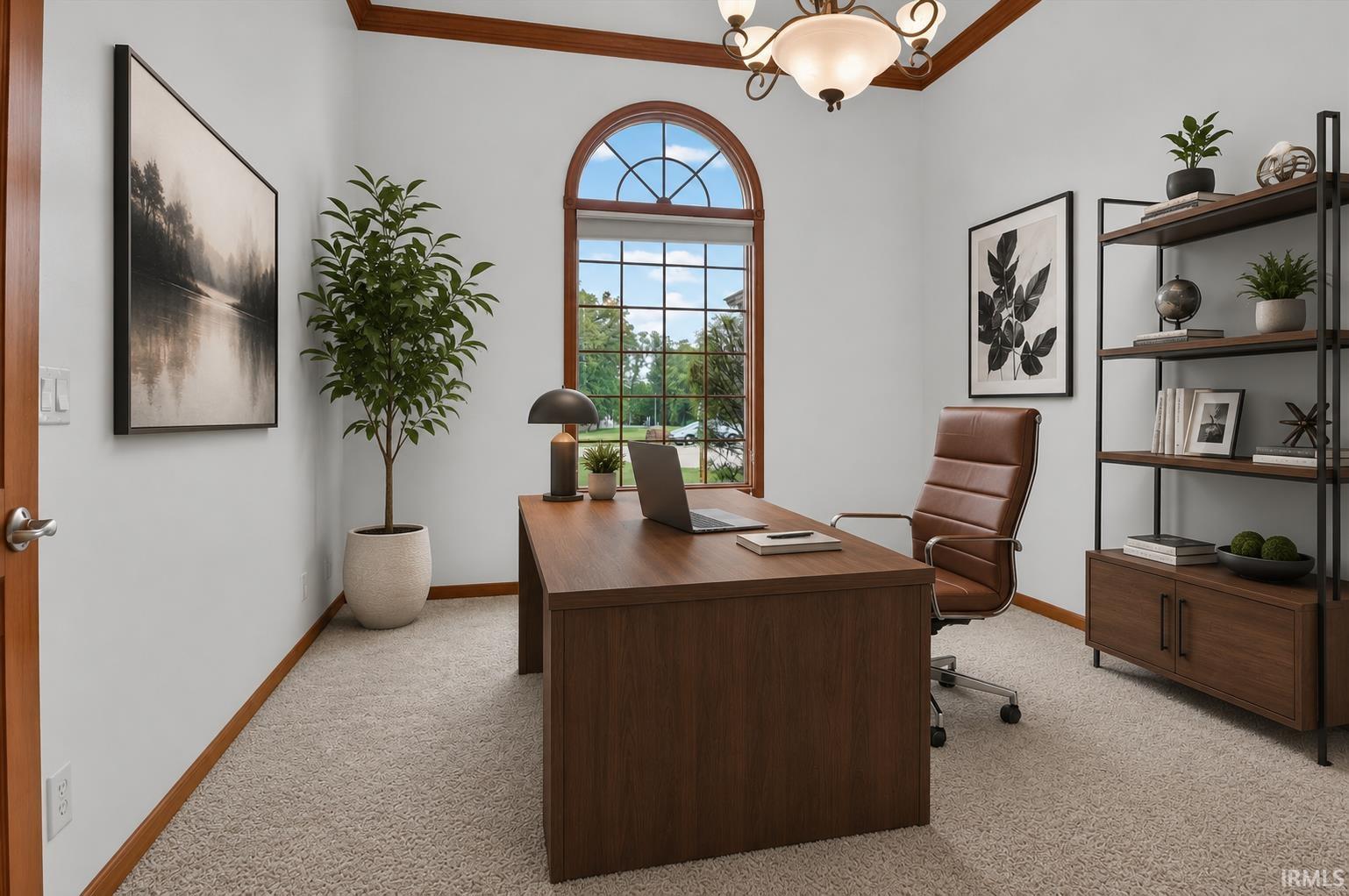 Office space featuring an arched window, textured carpet flooring, and a chandelier light fixture