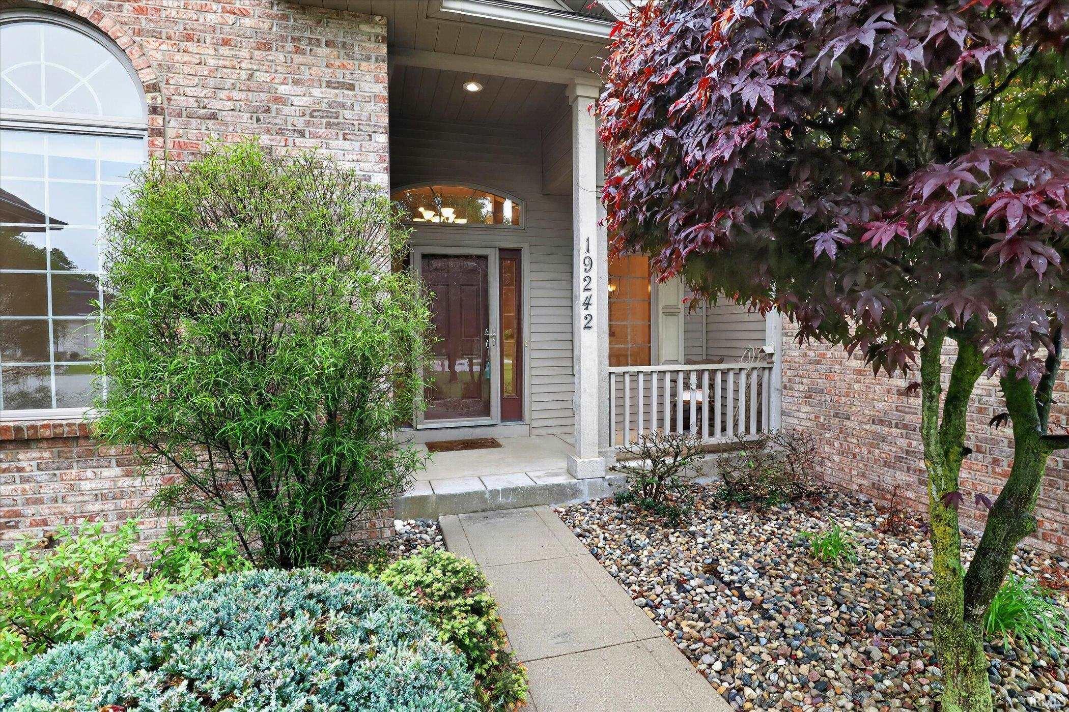 Brick facade featuring an arched transom window and a covered front entry