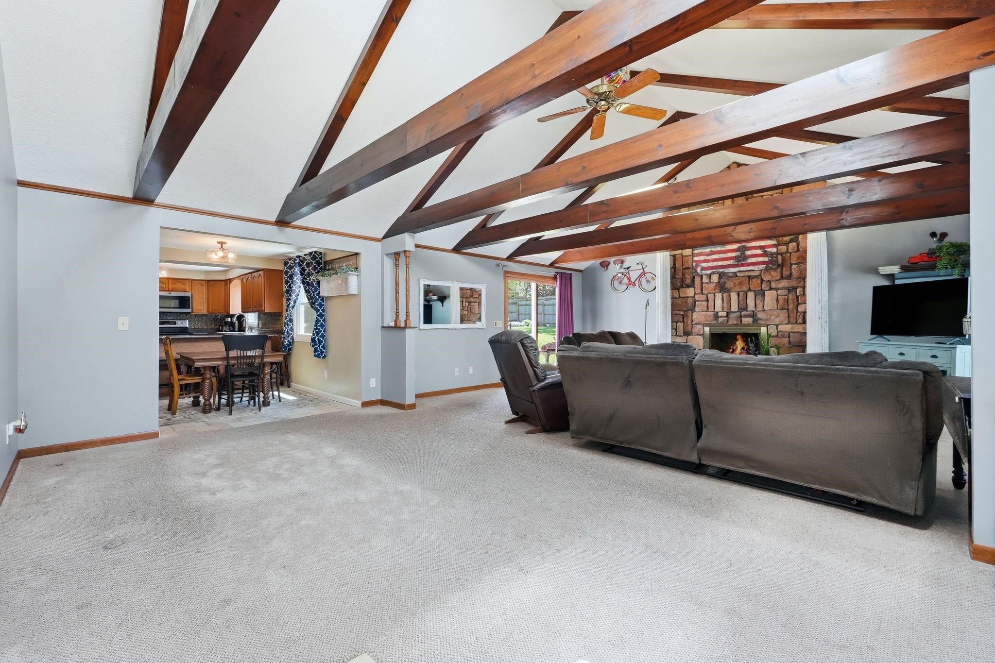 Vaulted ceiling featuring exposed wood beams