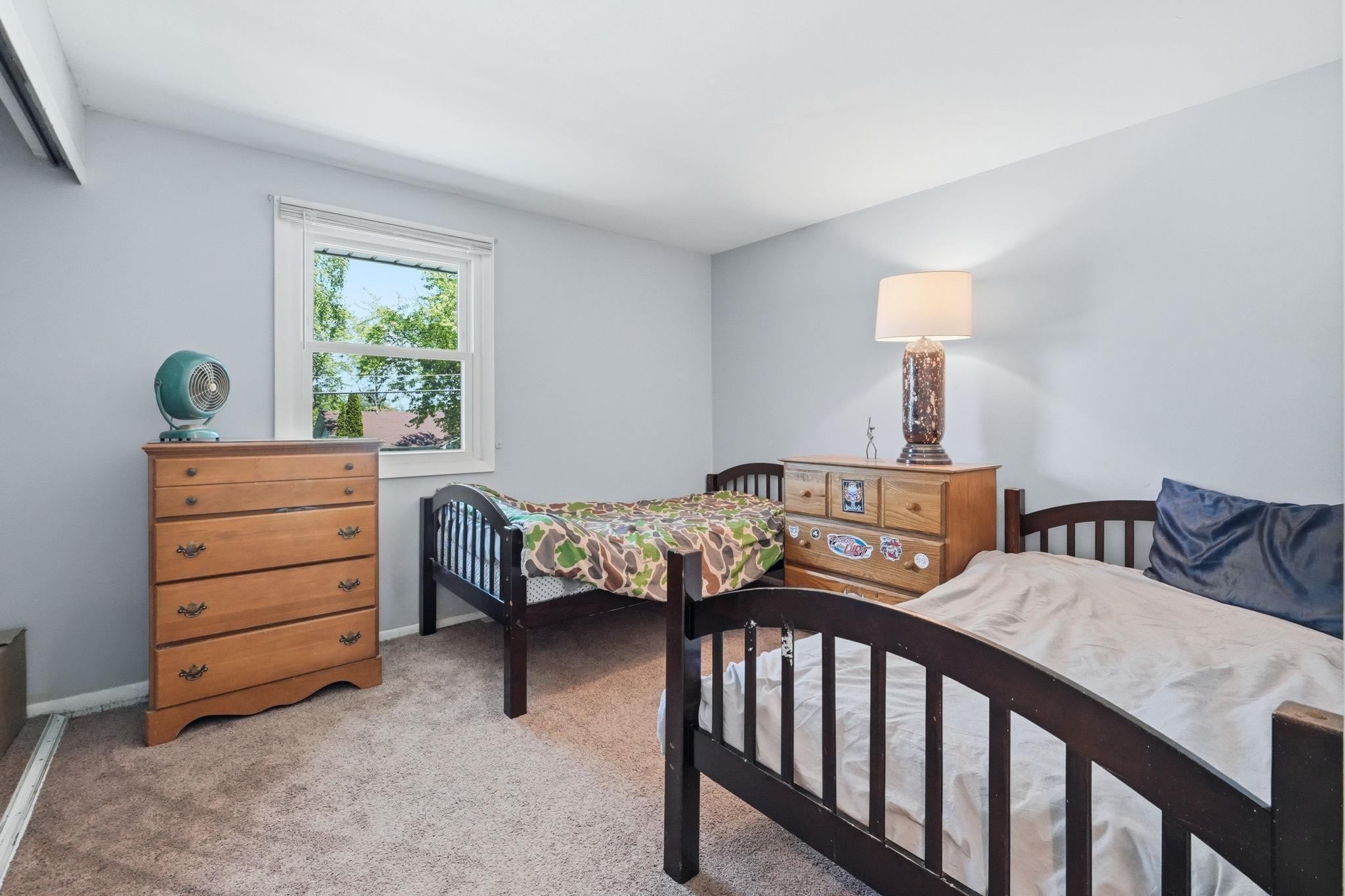 Carpeted room with light blue walls and white trim