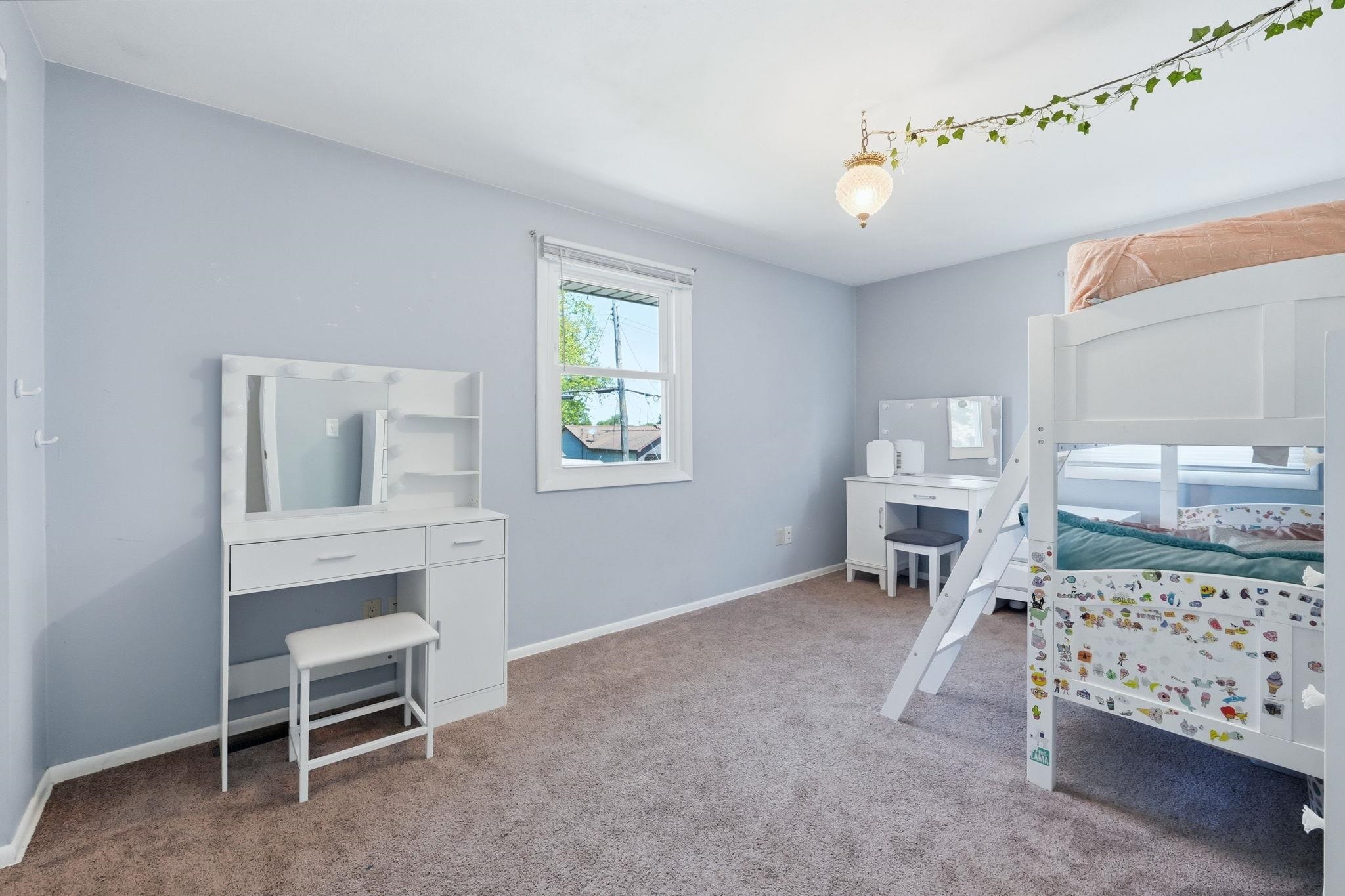 Neutral wall paint, window with white trim, ceiling-mounted light fixture, and carpeted flooring