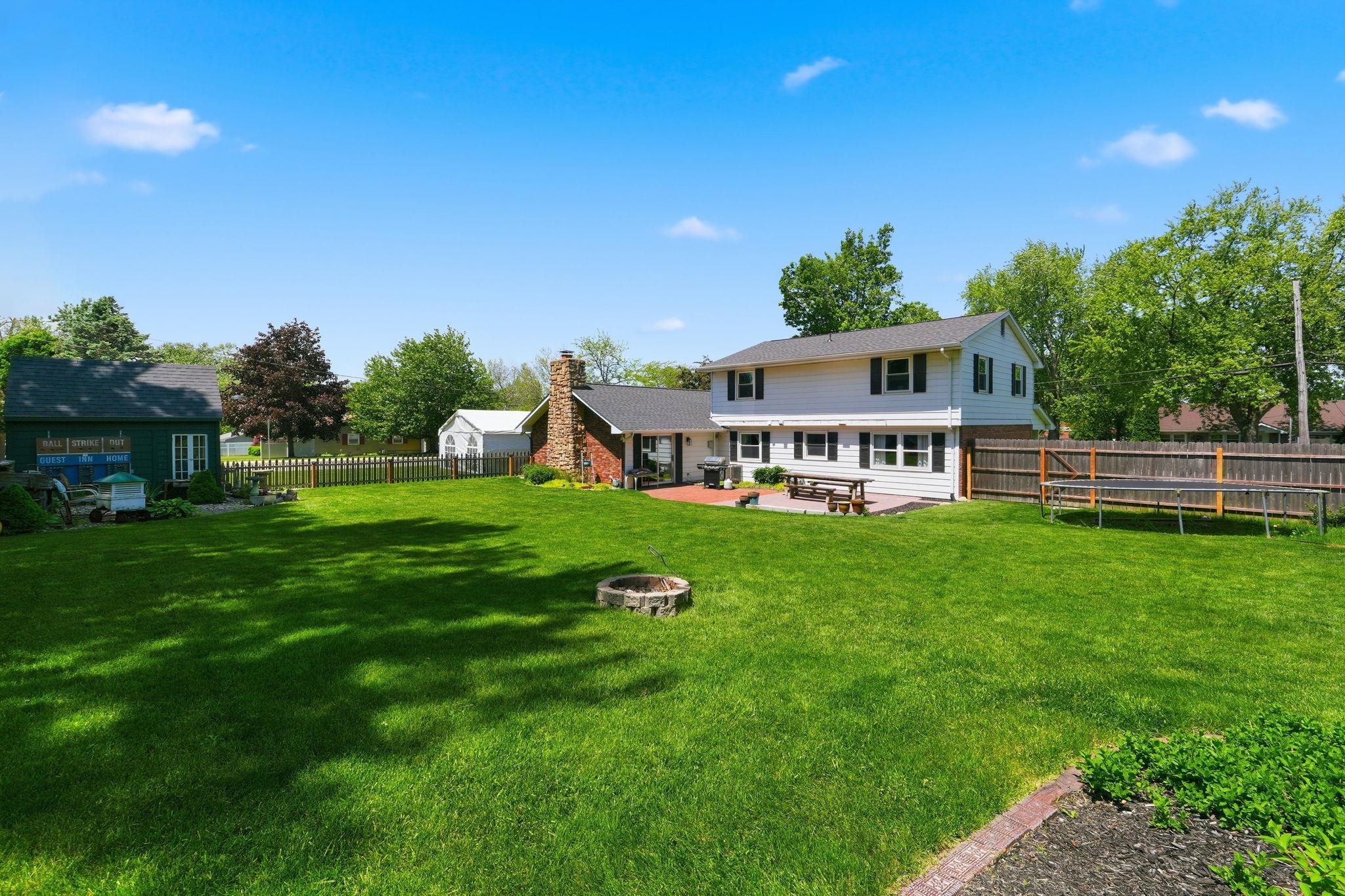 Expansive lawn with a fire pit feature