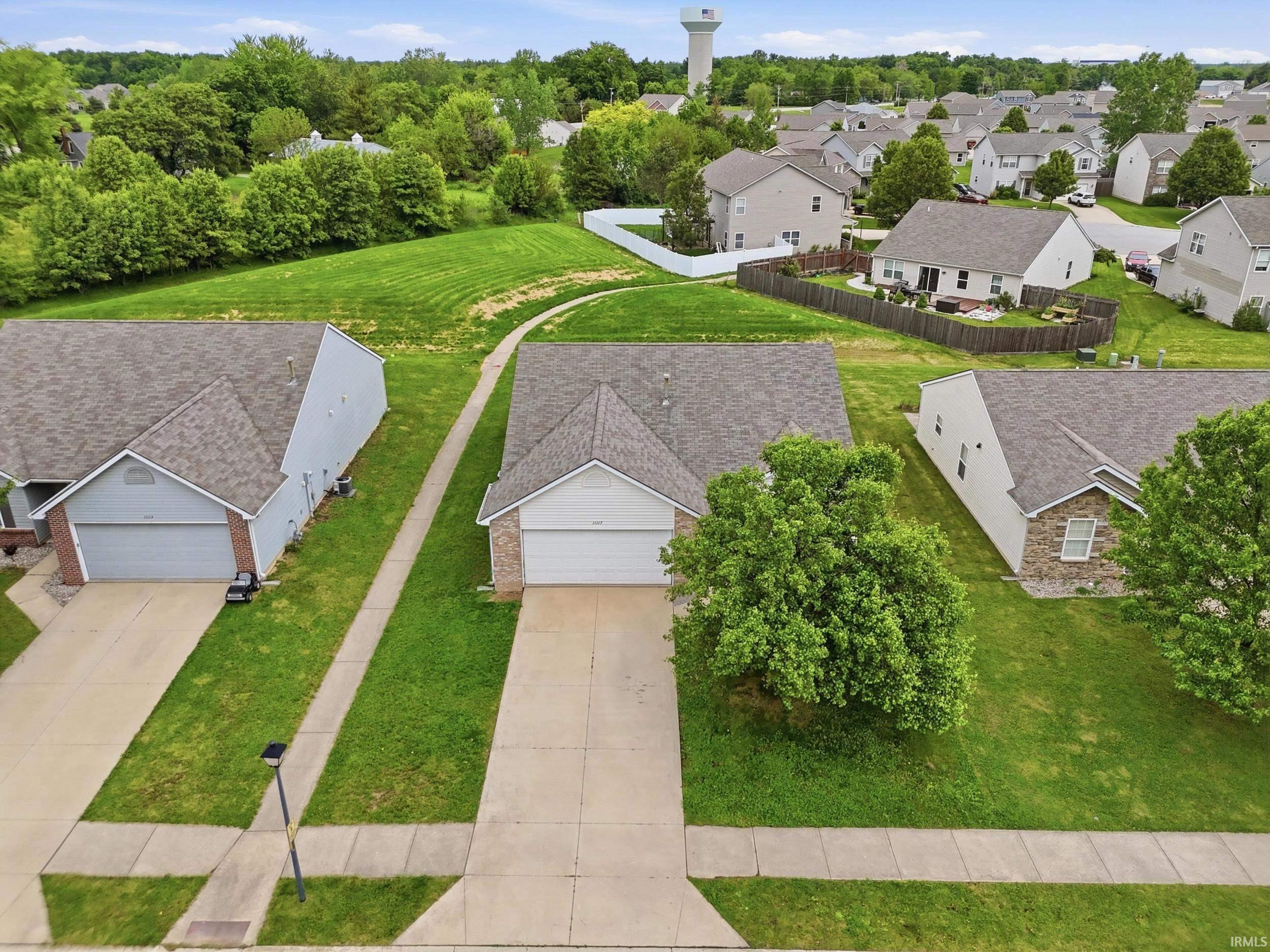 Single-story residence featuring a two-car garage, concrete driveway, and a shingled roof