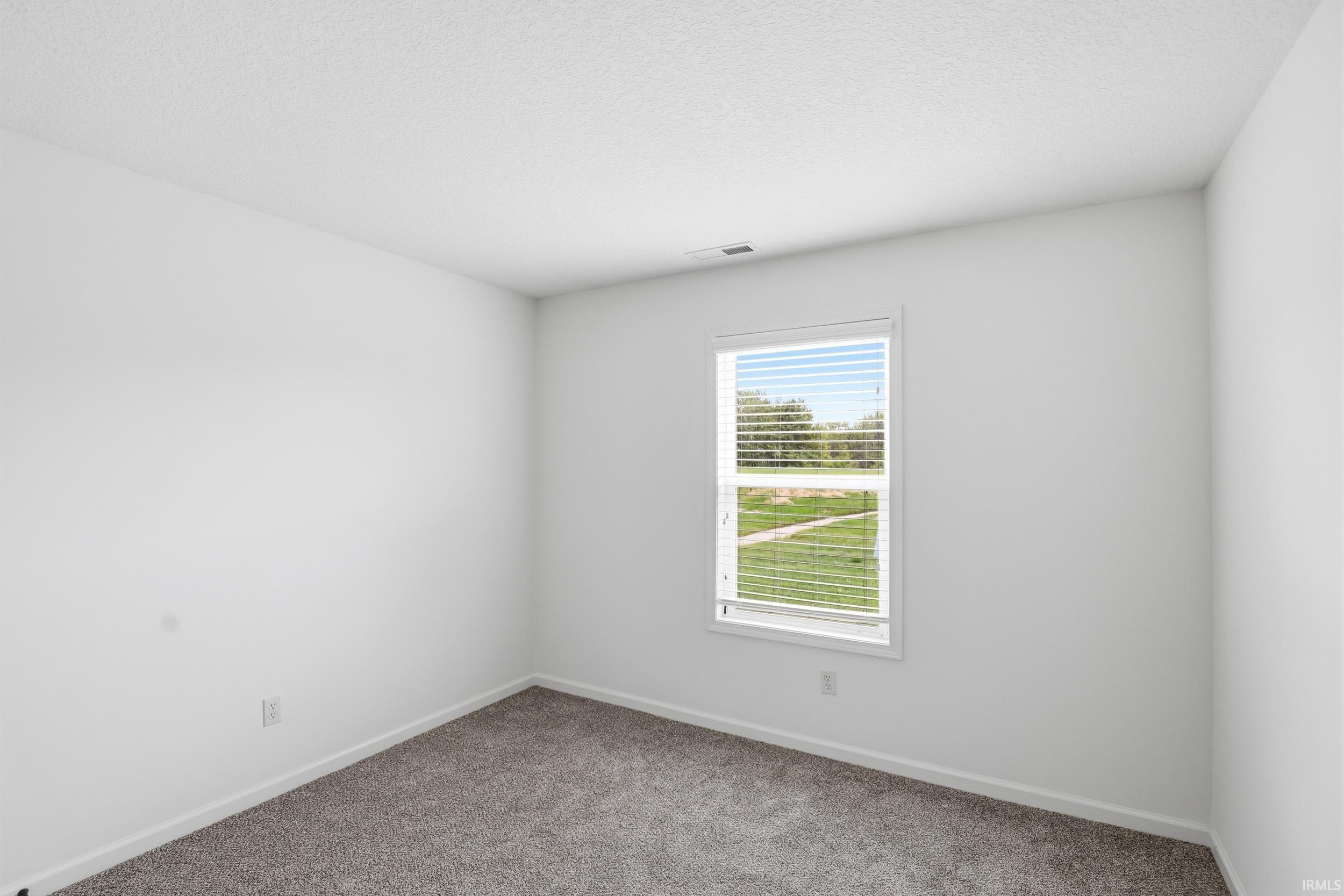 Crisp interior with neutral wall paint and grey carpeting