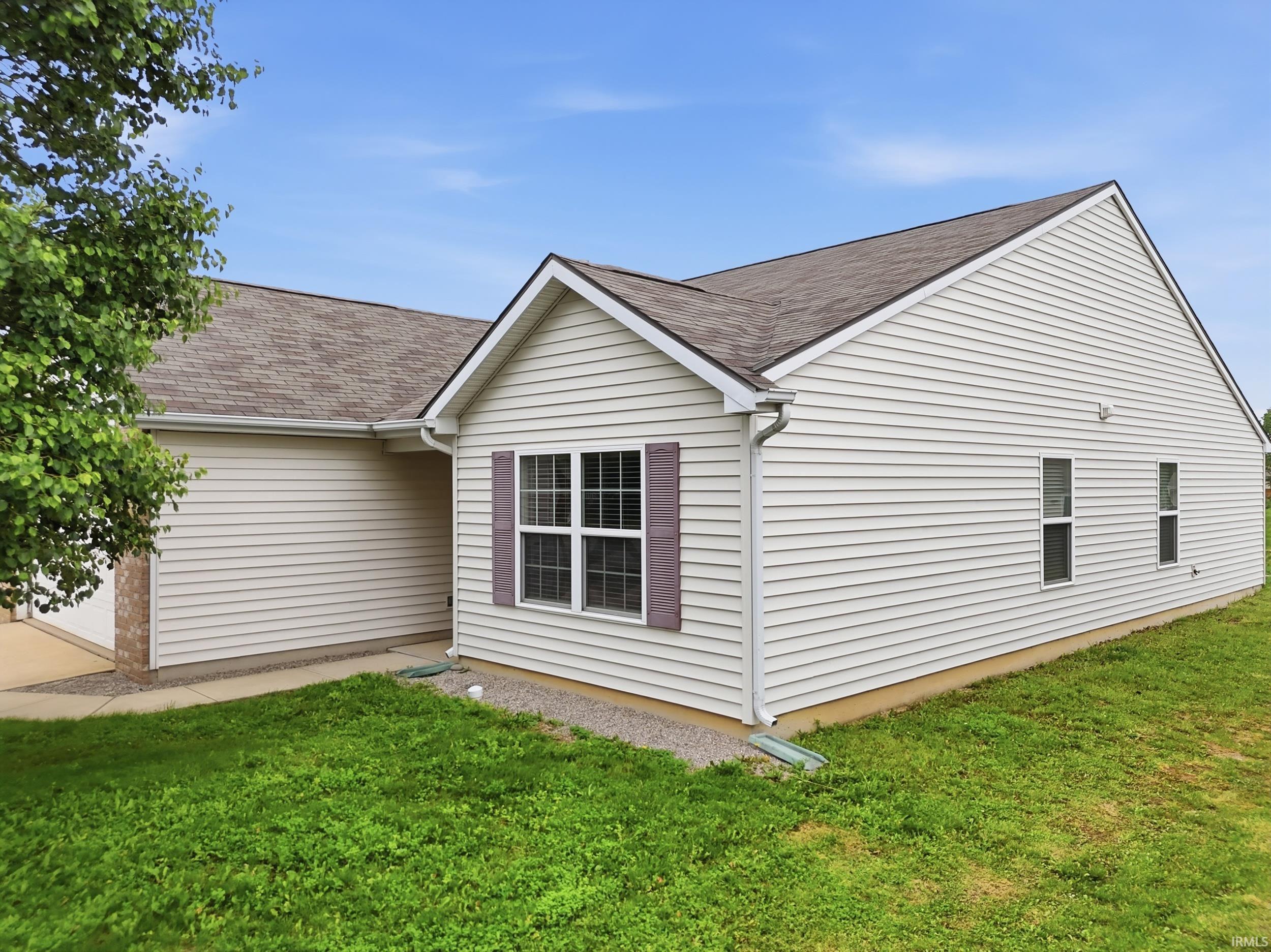 White vinyl siding exterior with an asphalt shingle roof