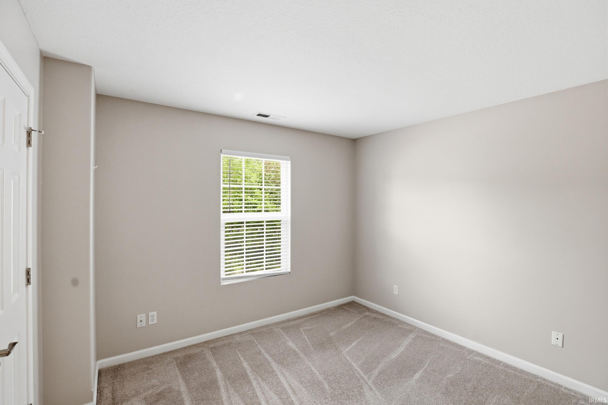 Neutral-toned interior with carpet flooring