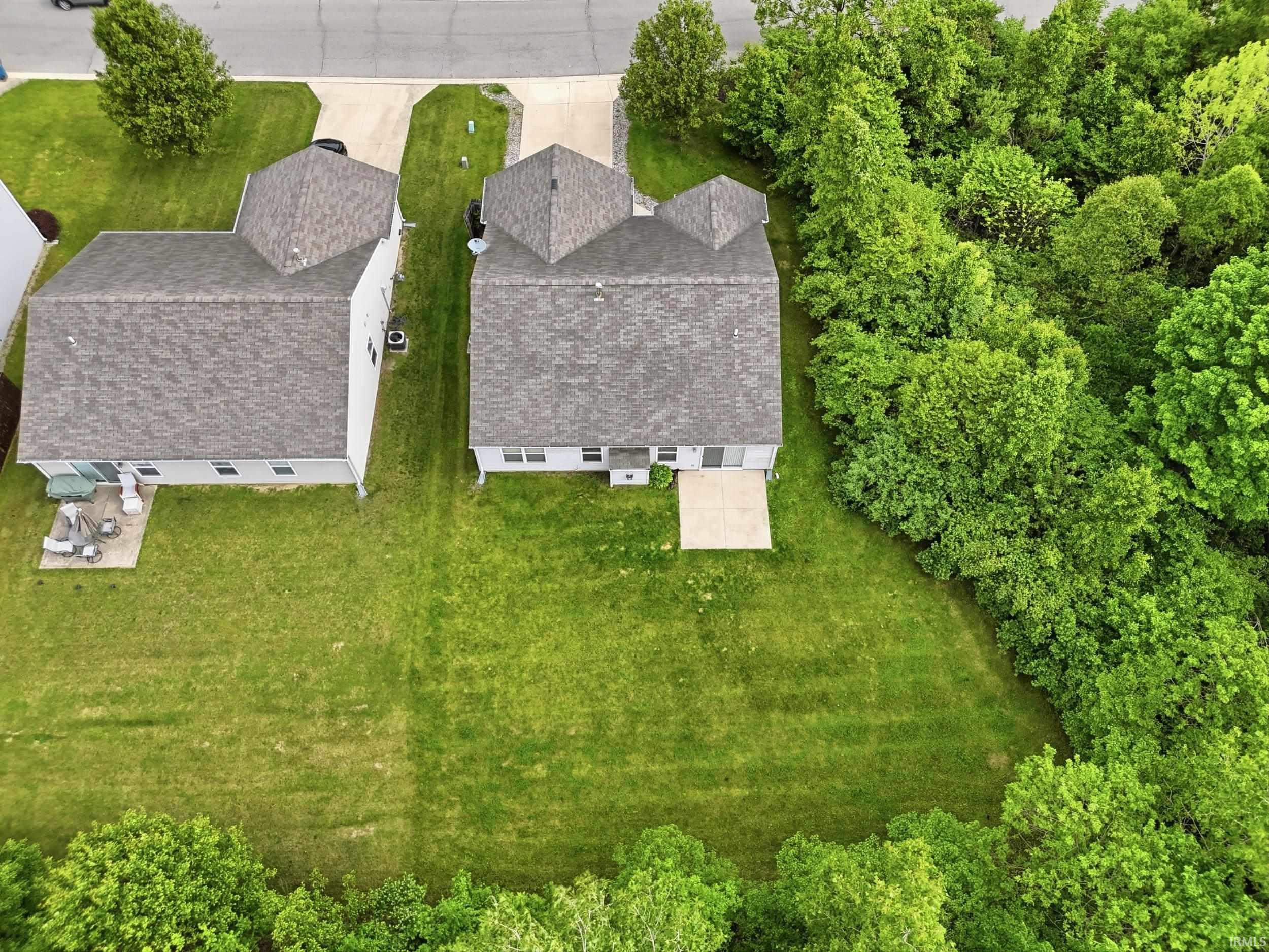 Expansive green lawn bordering a dense tree line