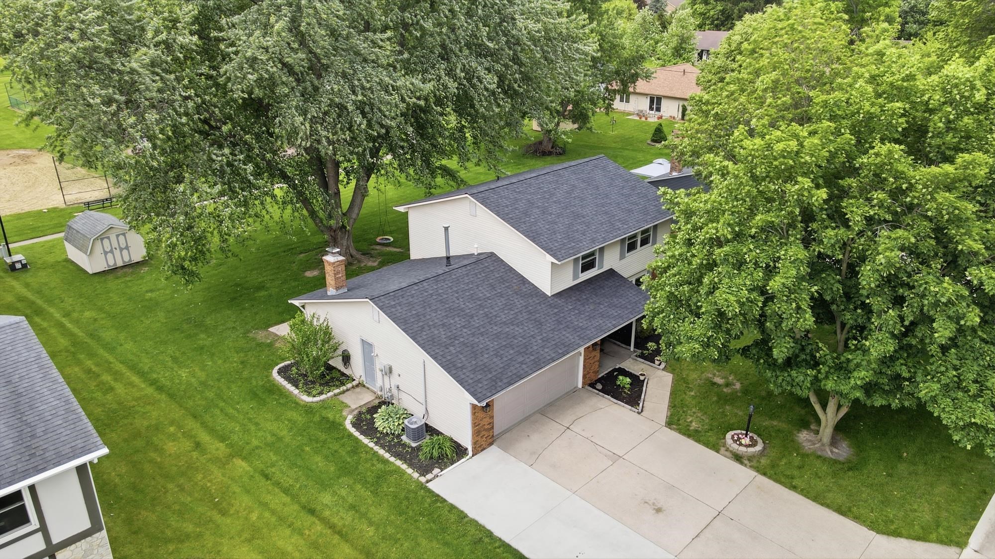 Two-story residence featuring a dark gray asphalt shingle roof