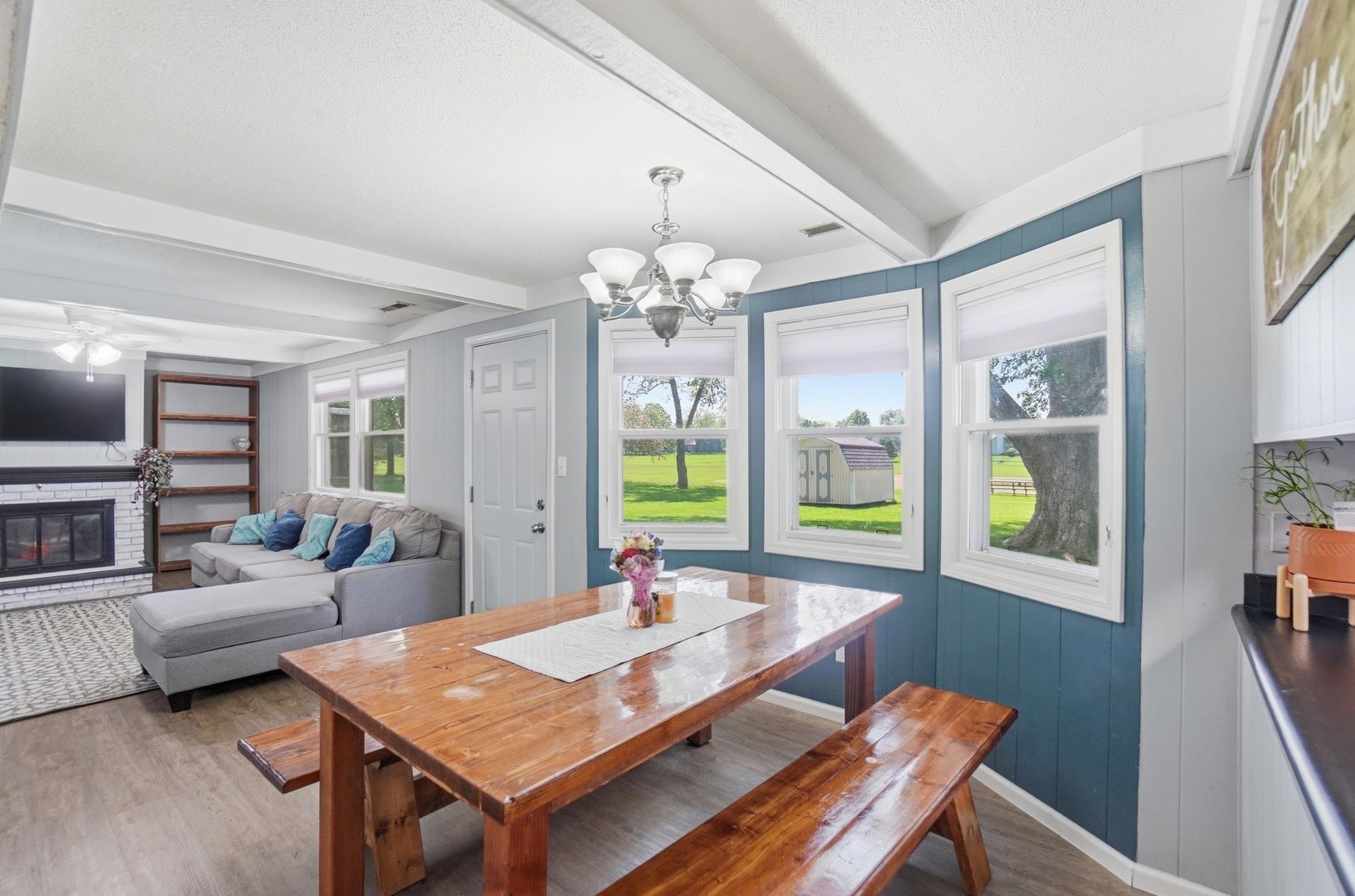 Dining area featuring wood-finish flooring and a bay window with a multi-pane design