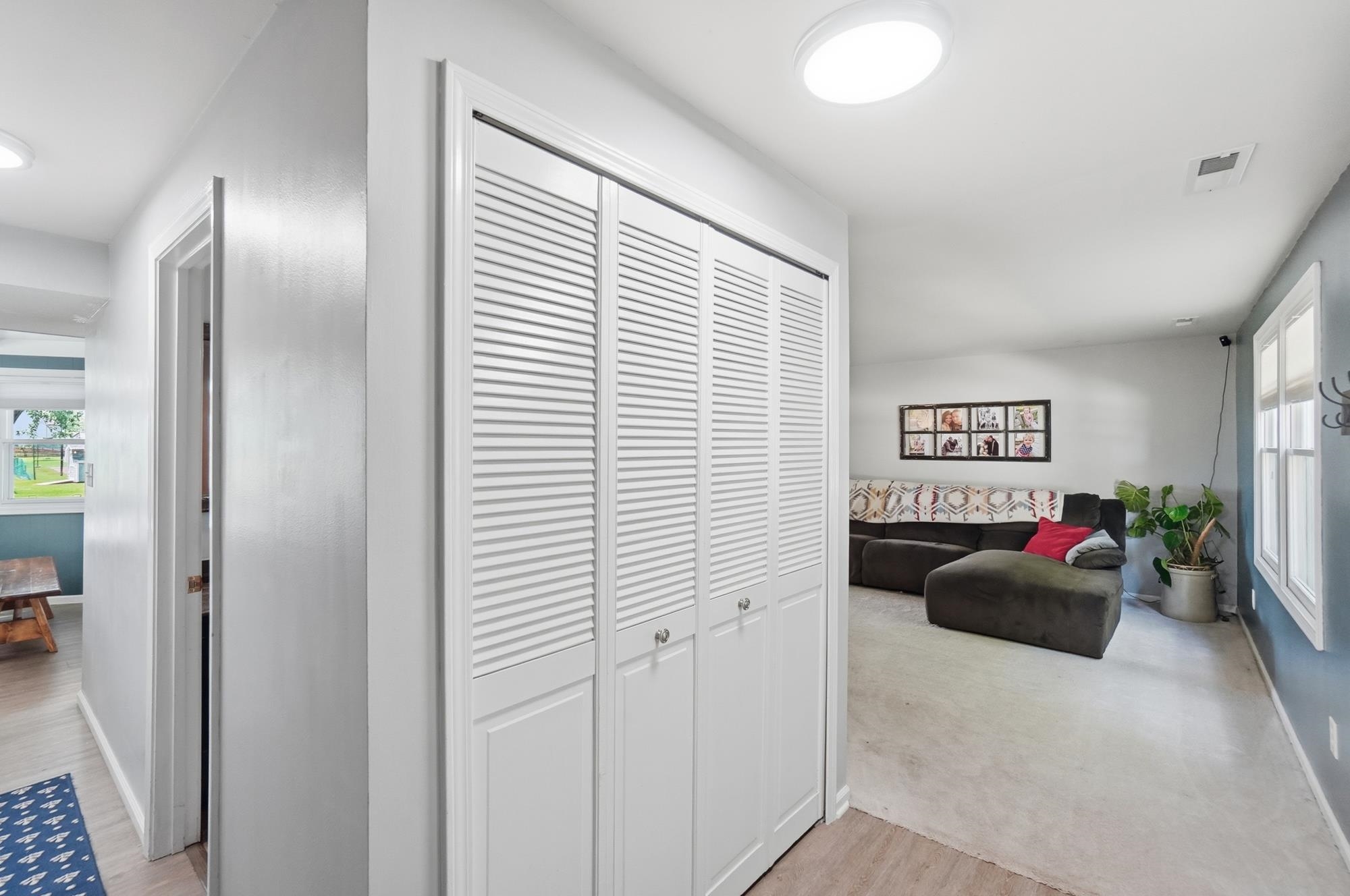 White louvered bifold closet doors with brushed nickel hardware