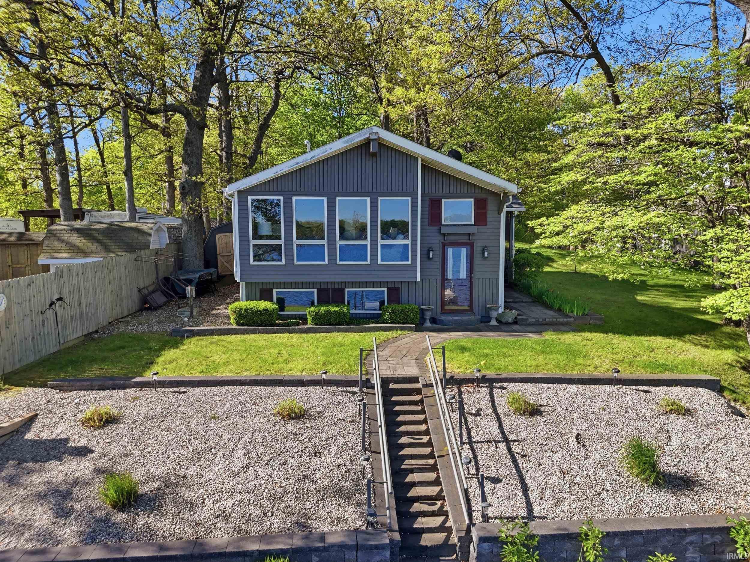 Grey siding exterior with red window shutters