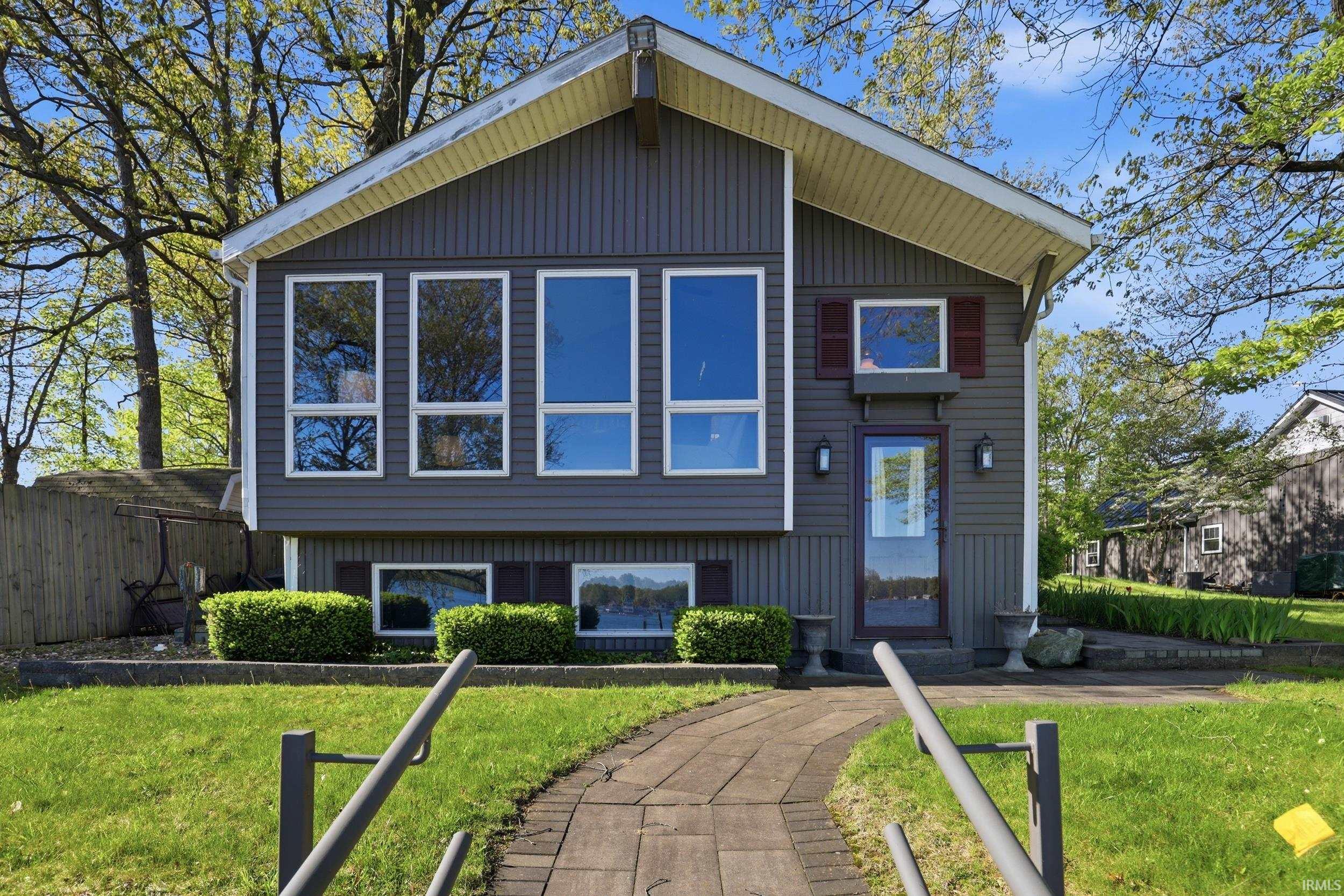 Gray siding exterior with multiple large windows