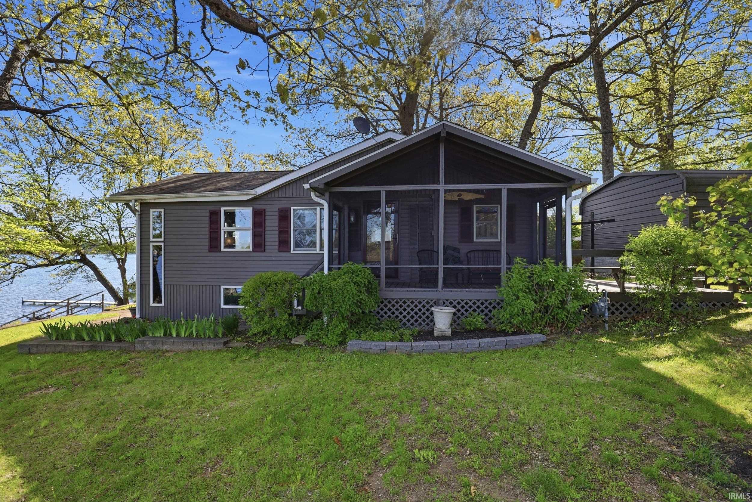 Exterior siding in a neutral gray hue with contrasting red shutters