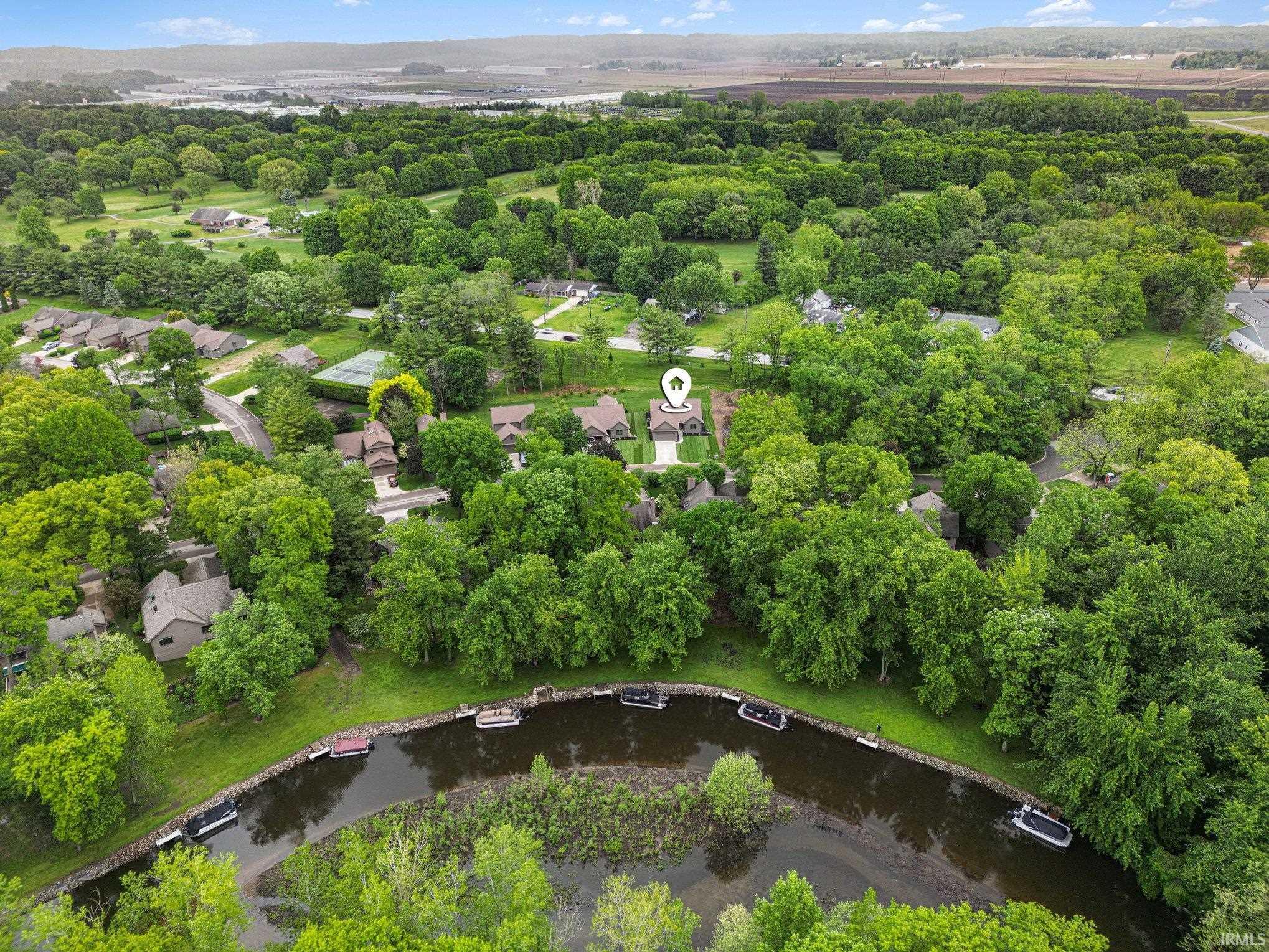 Aerial panorama showcasing a residential property amidst abundant mature trees