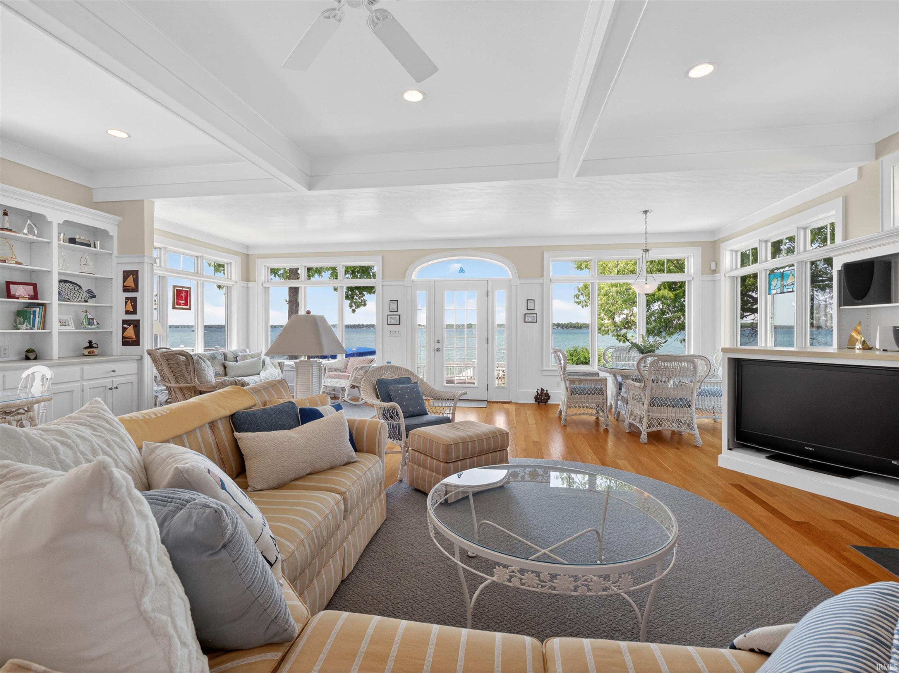 Spacious living area featuring wood-finish flooring, recessed lighting, and a white ceiling fan