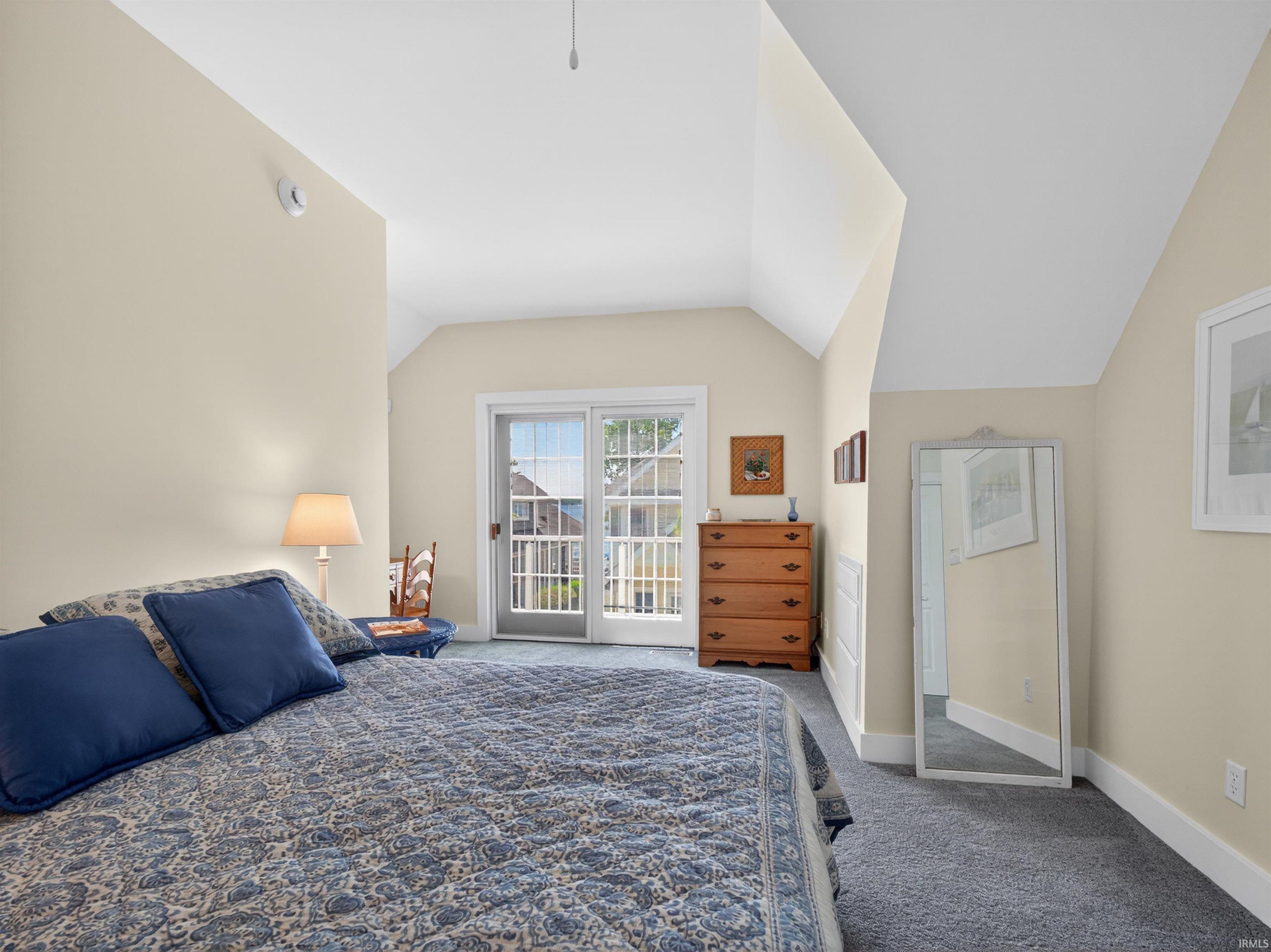 Room featuring a vaulted ceiling and light-colored walls