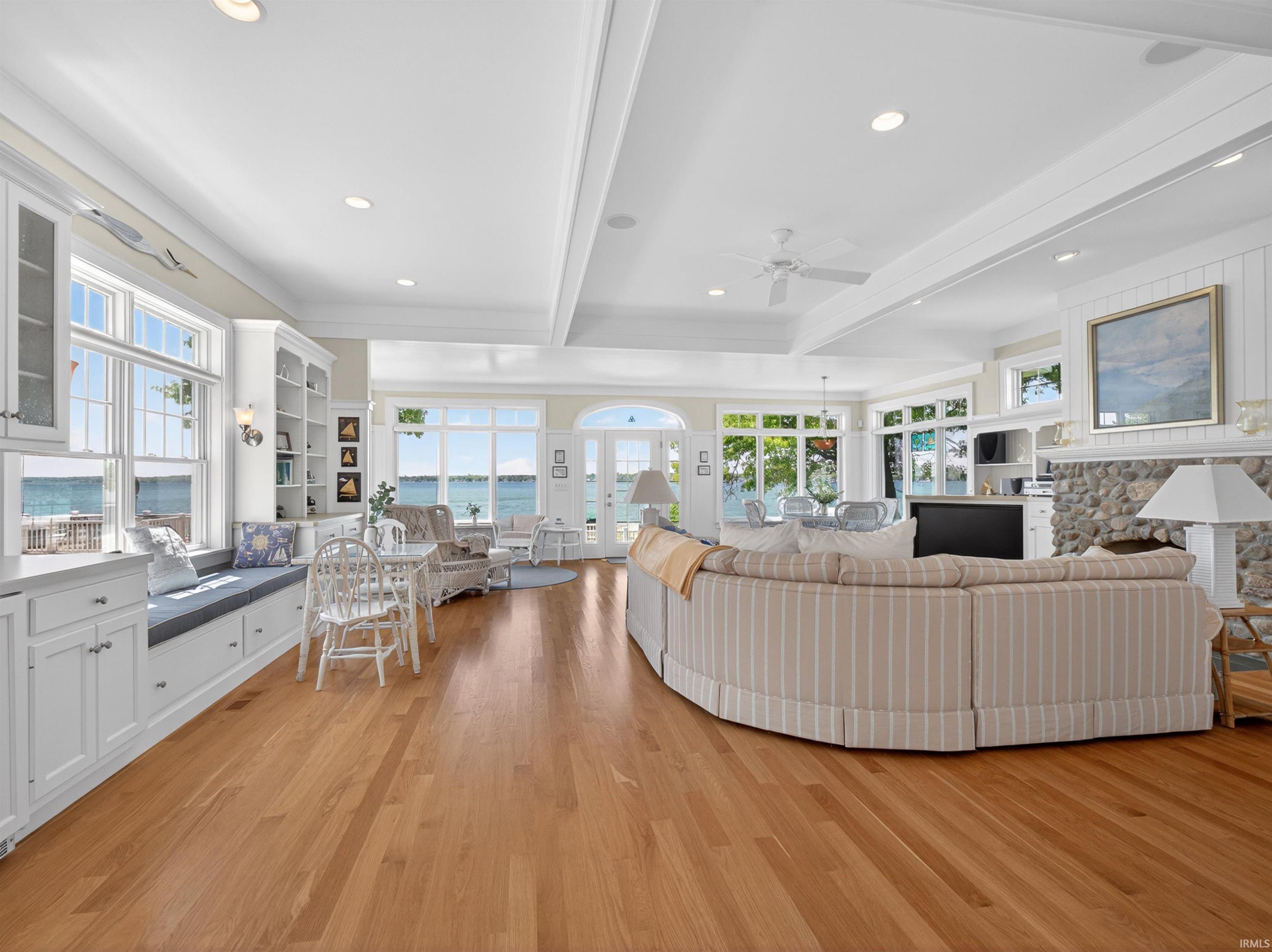 Open-concept living space featuring wood-finish flooring, recessed lighting, and expansive windows