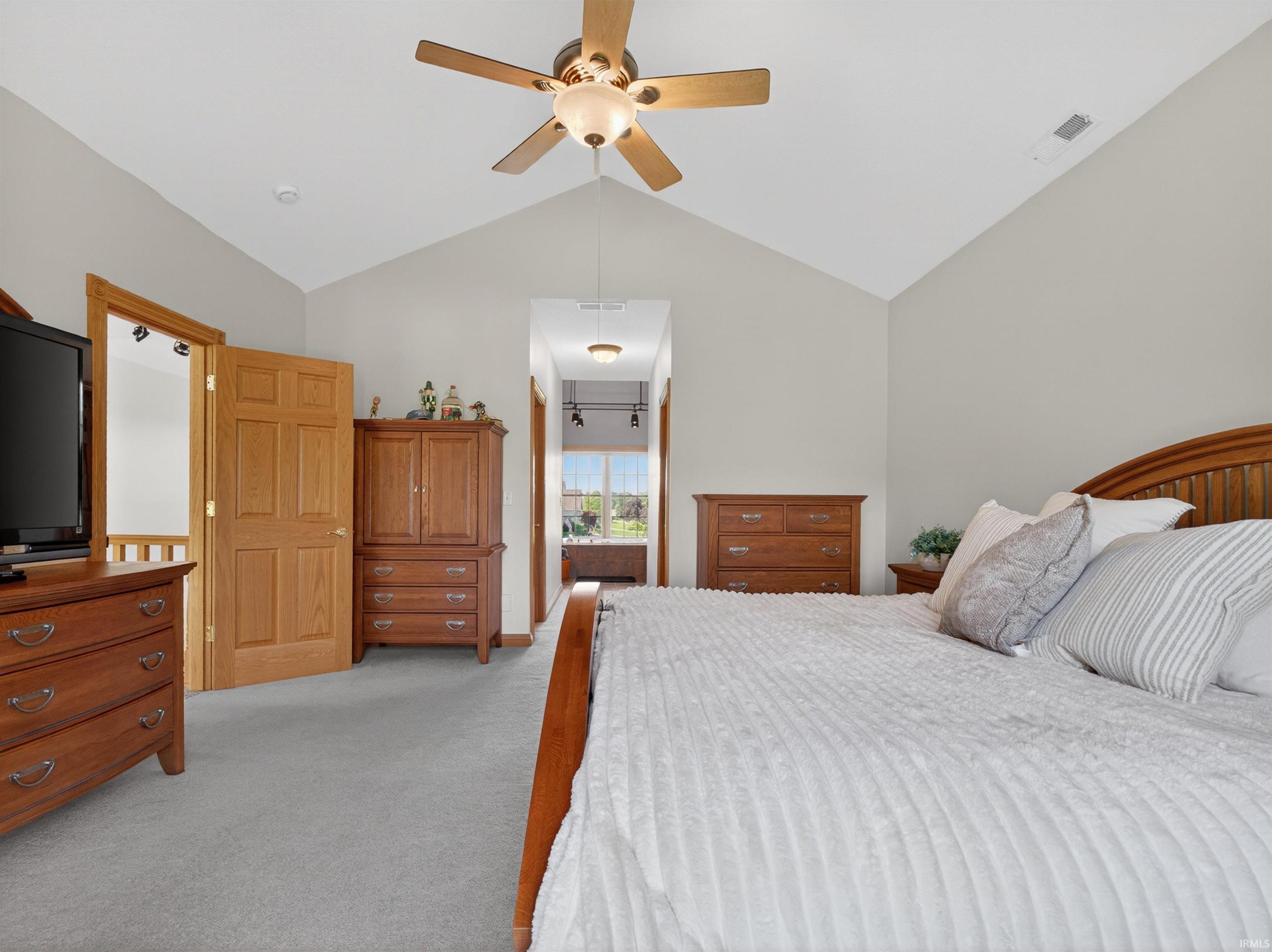 Vaulted ceiling with an overhead fan light fixture