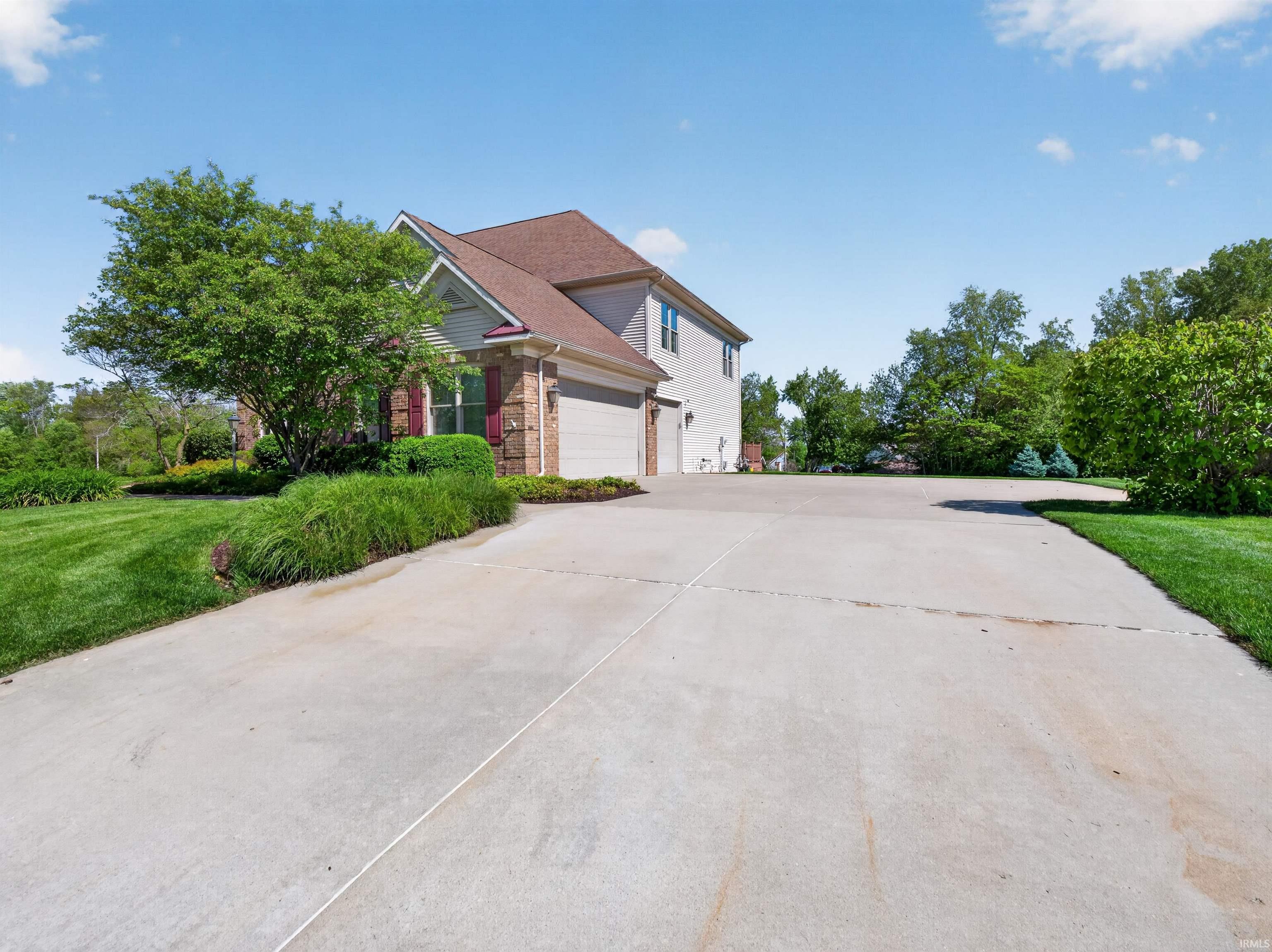 Expansive concrete driveway with a two-car garage