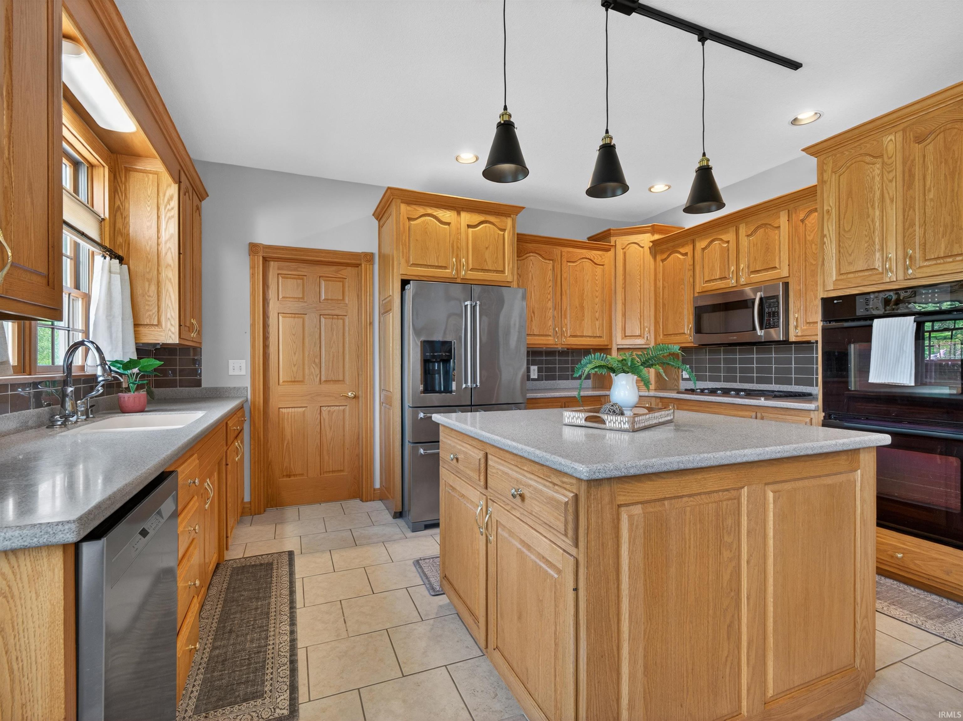 Kitchen featuring light wood cabinetry and a central island with a light-toned countertop