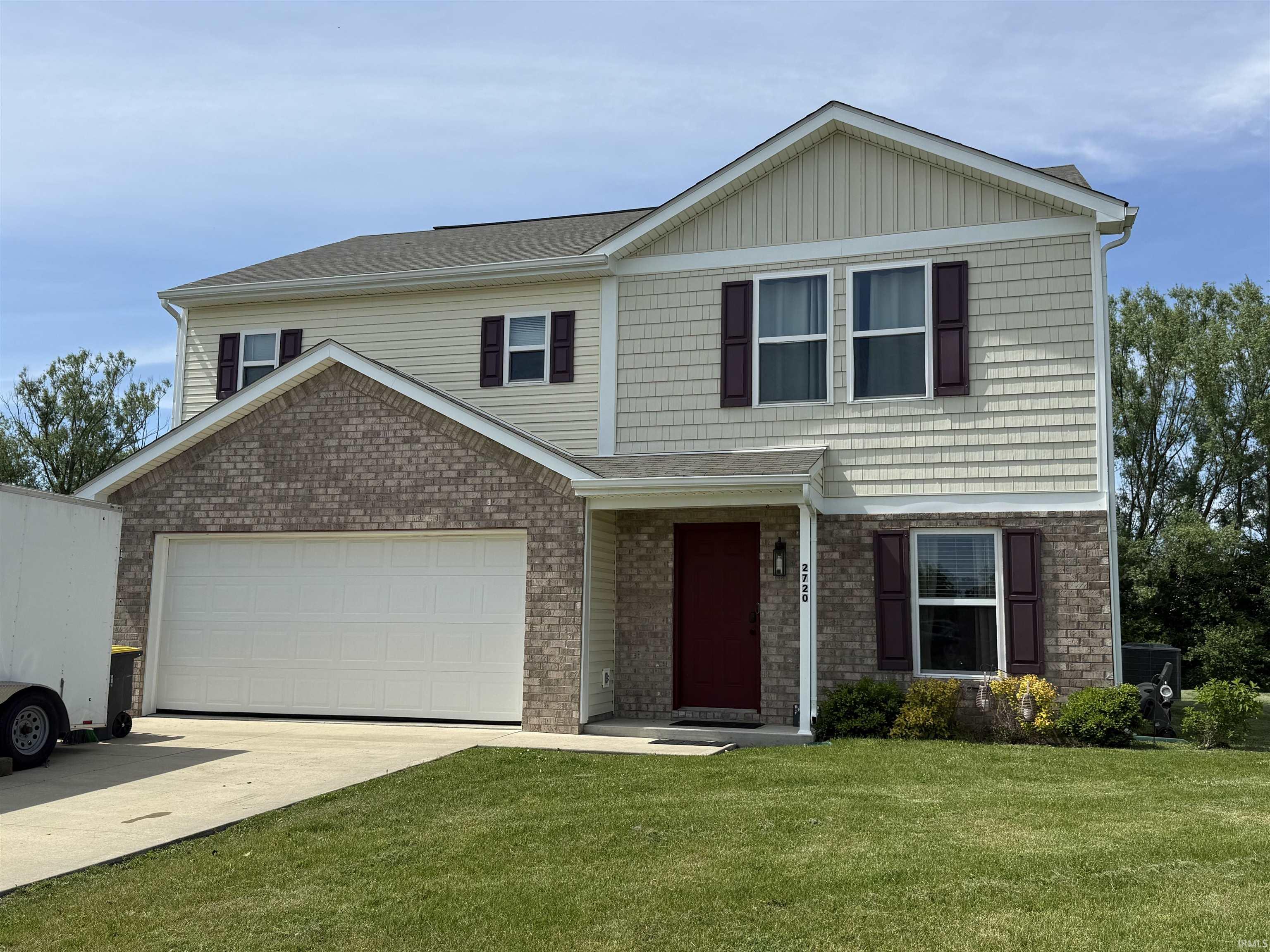 Two-story residence featuring a combination of brick and siding exterior