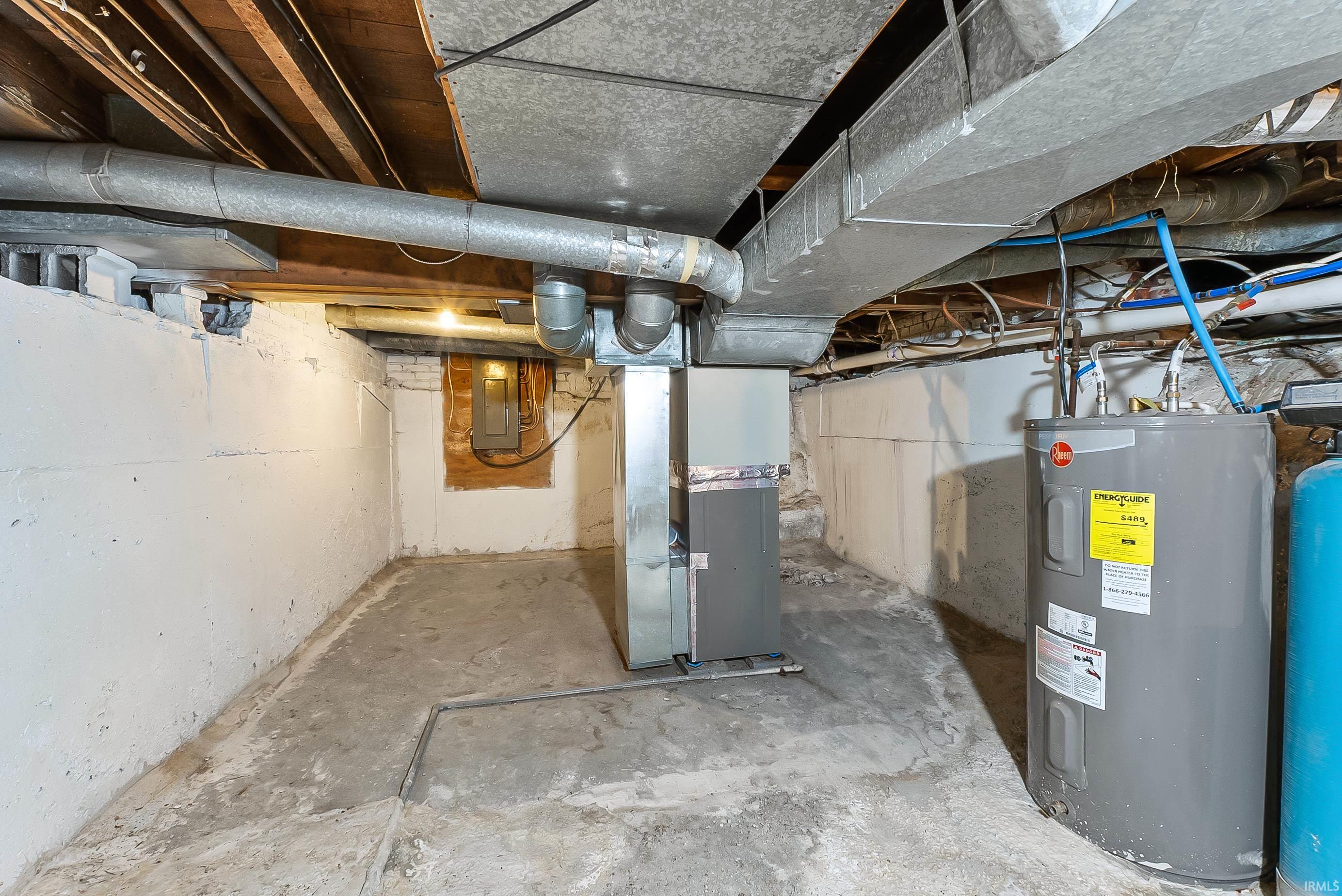 Utility space featuring a water heater, furnace, and exposed ceiling joists with ductwork