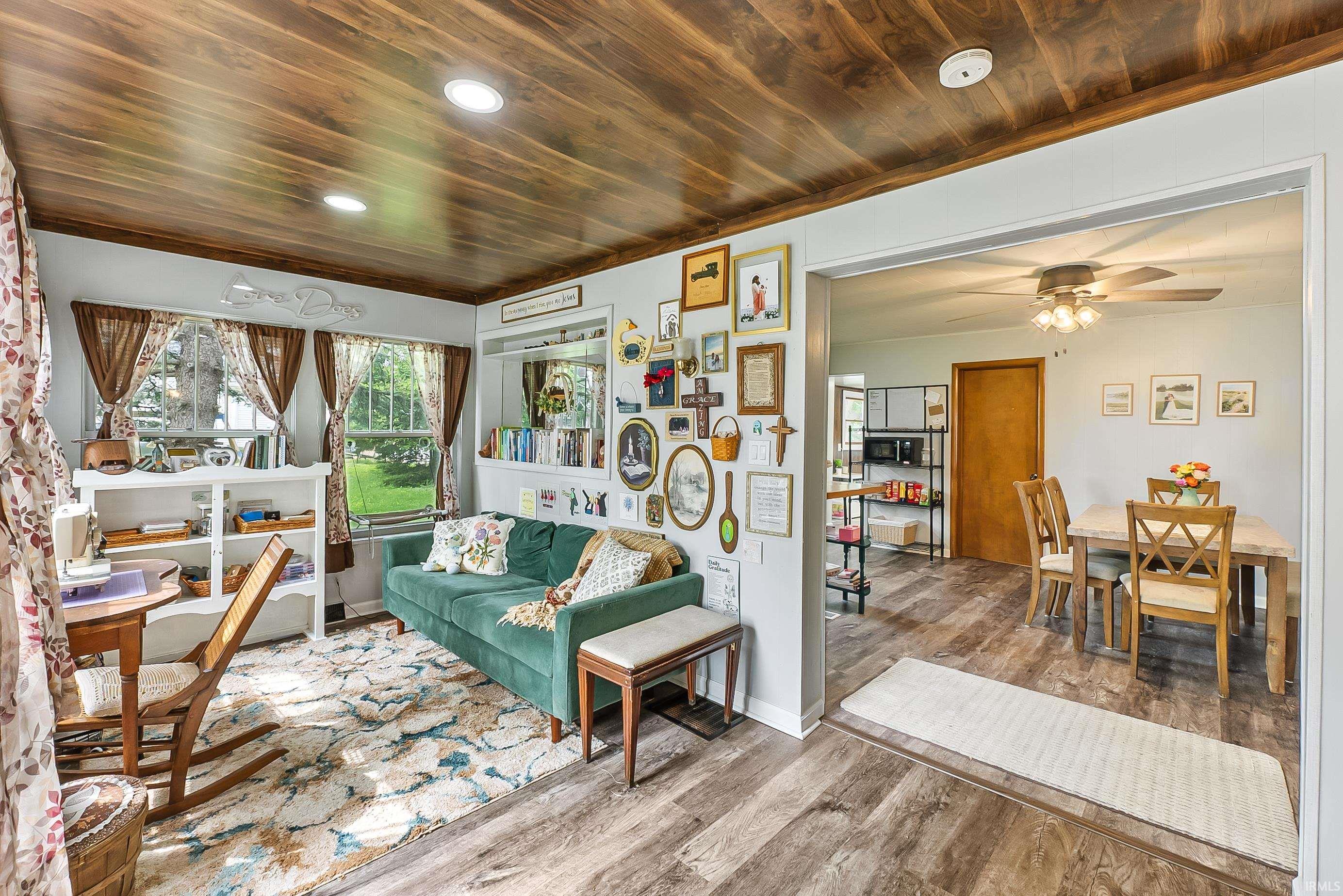 Wood-finish ceiling and flooring frame this versatile living space