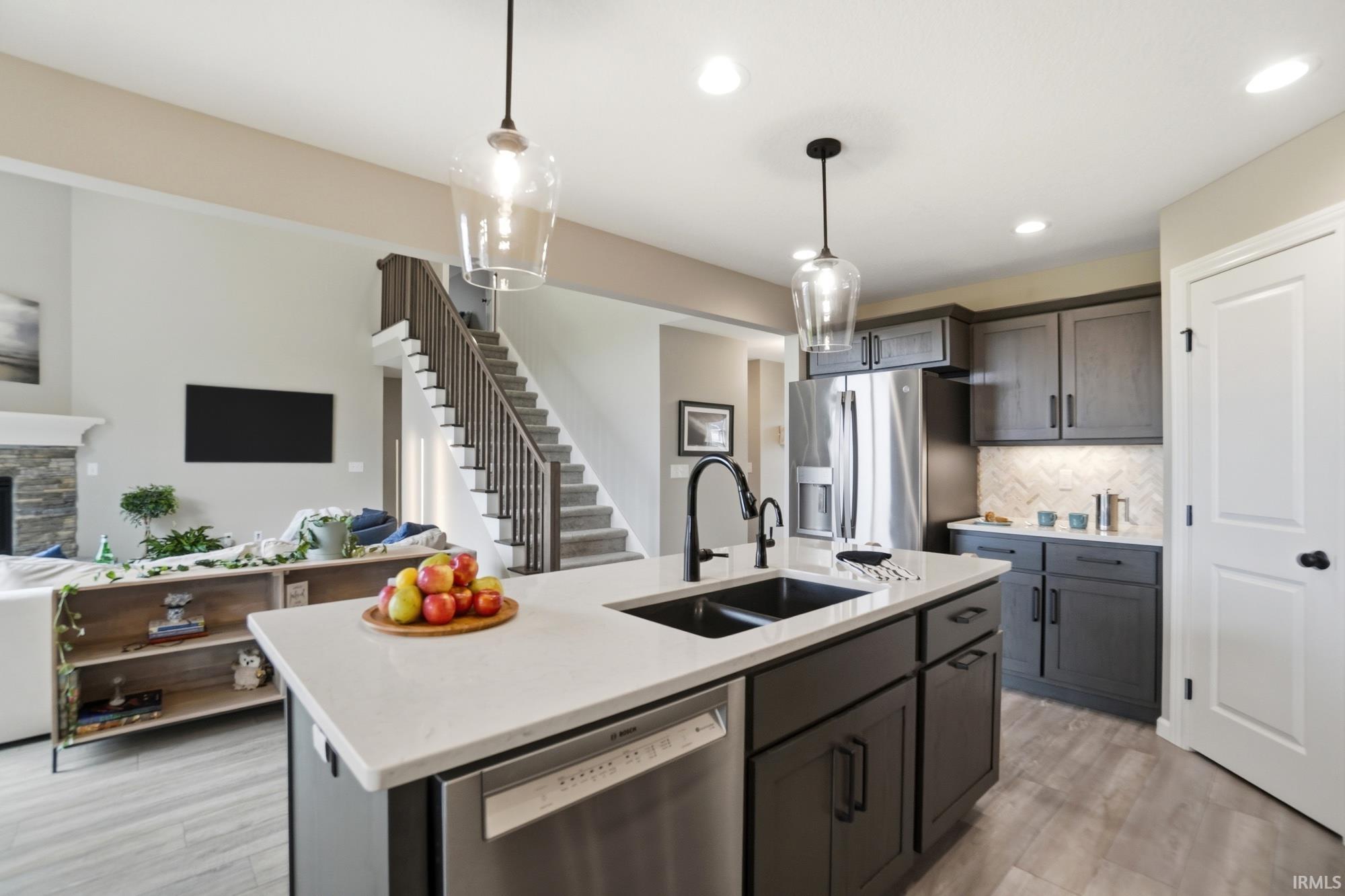 Kitchen island with undermount double sink, quartz countertop, and integrated dishwasher