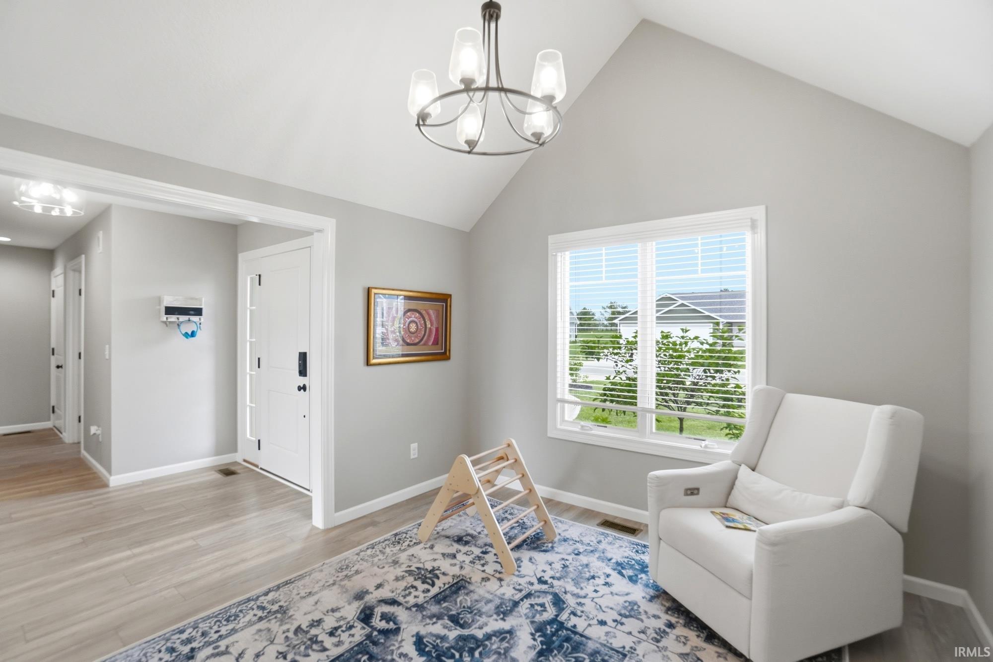 Vaulted ceiling with a contemporary chandelier and light gray walls