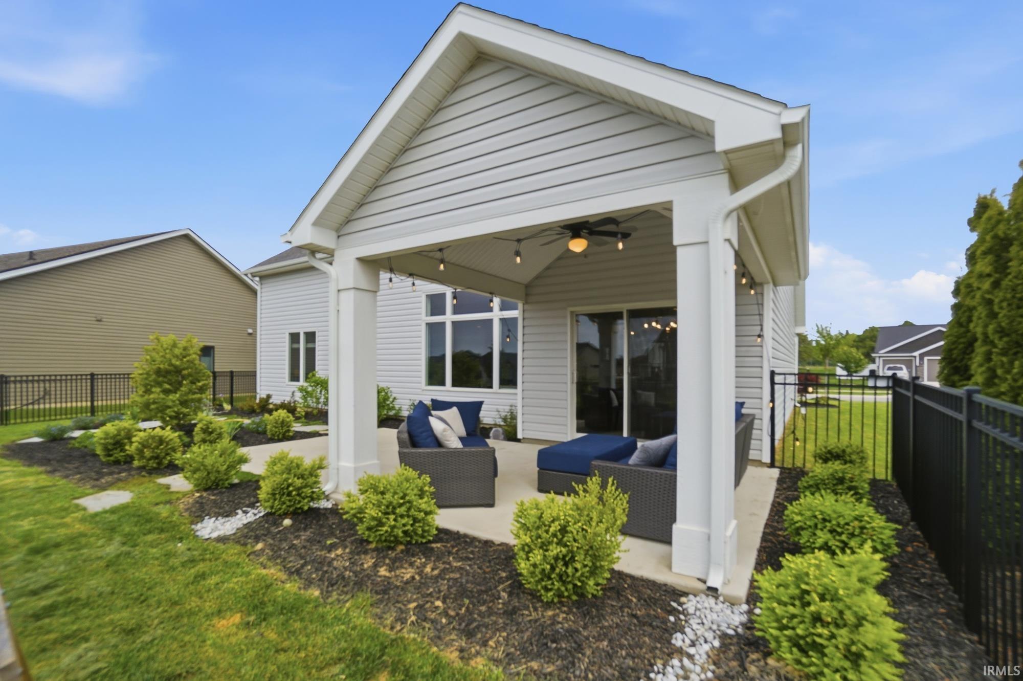 Covered patio featuring a ceiling fan and string lighting