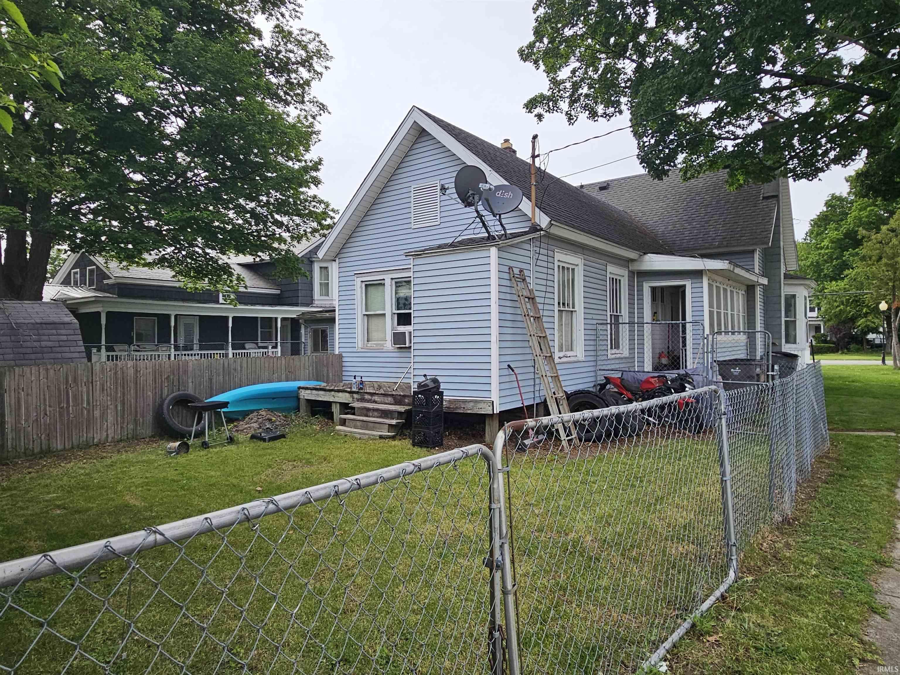 Light blue siding exterior with white trim windows and a dark shingled roof