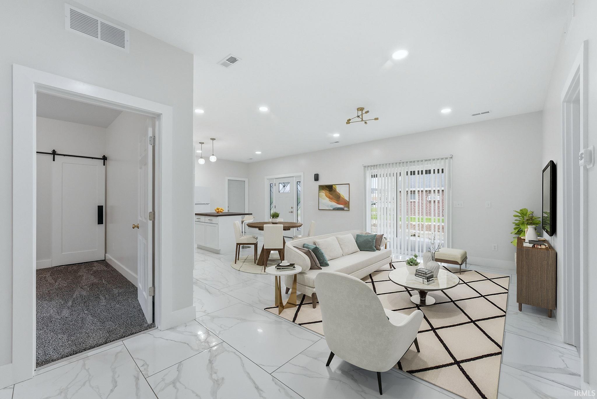 Open-concept interior featuring large format marble-look tile flooring, recessed lighting, a modern ceiling fixture, and sliding glass doors