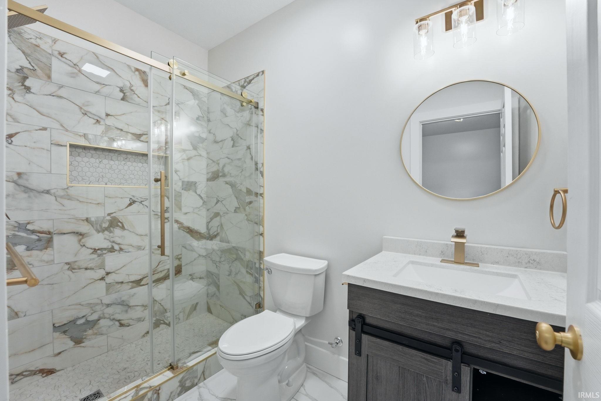 Shower with floor-to-ceiling marble-look tile and a built-in niche