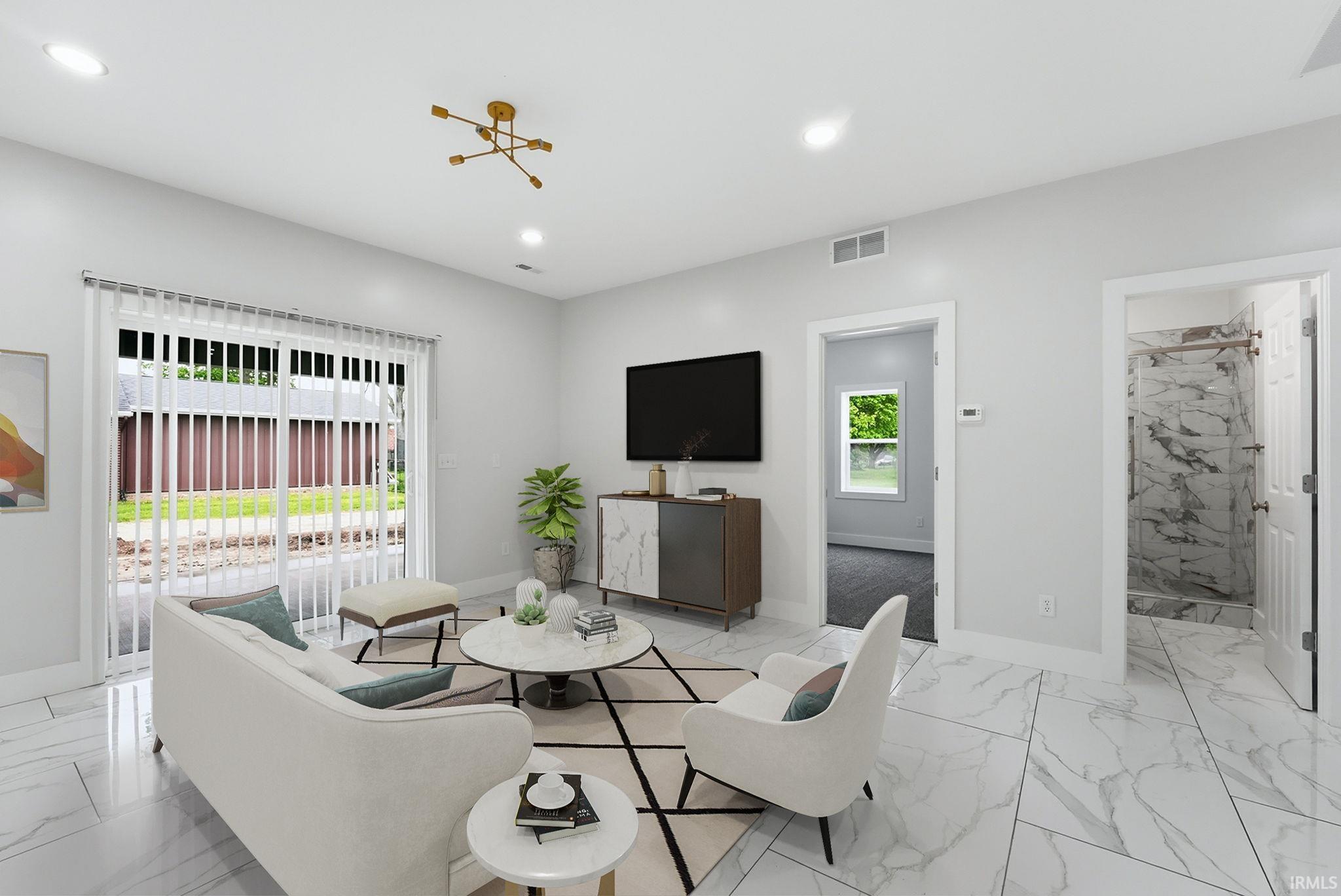 Spacious room featuring large format tile flooring, recessed lighting, and a modern gold-finish ceiling light fixture