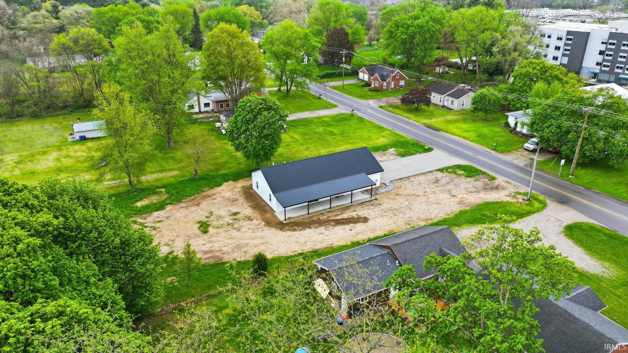 Newly constructed single-story residence featuring a dark-pitched roof and white siding