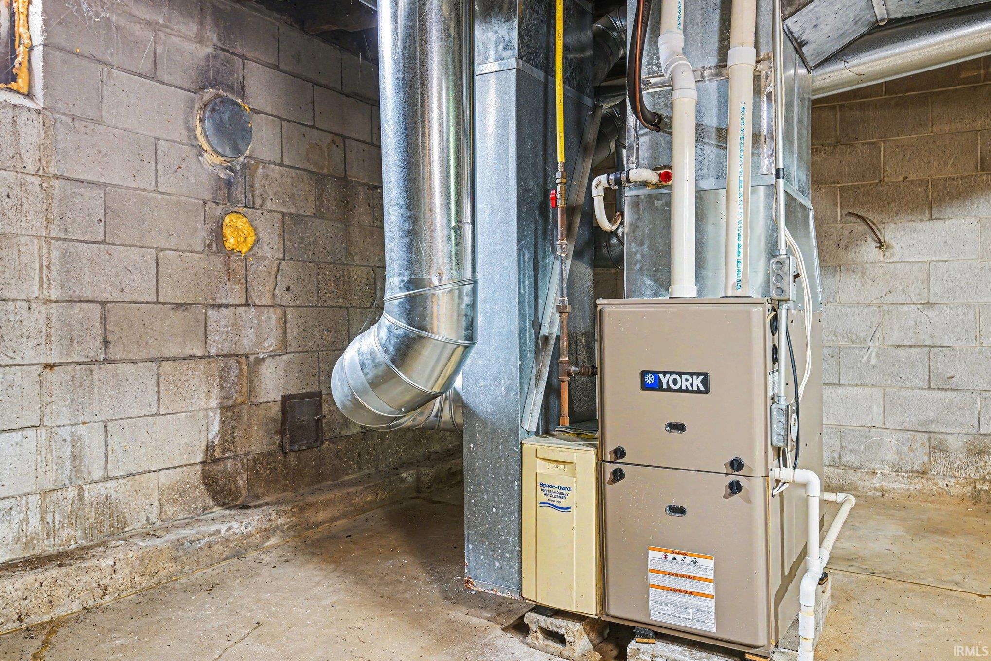 HVAC system featuring a York furnace, galvanized ductwork, and PVC piping