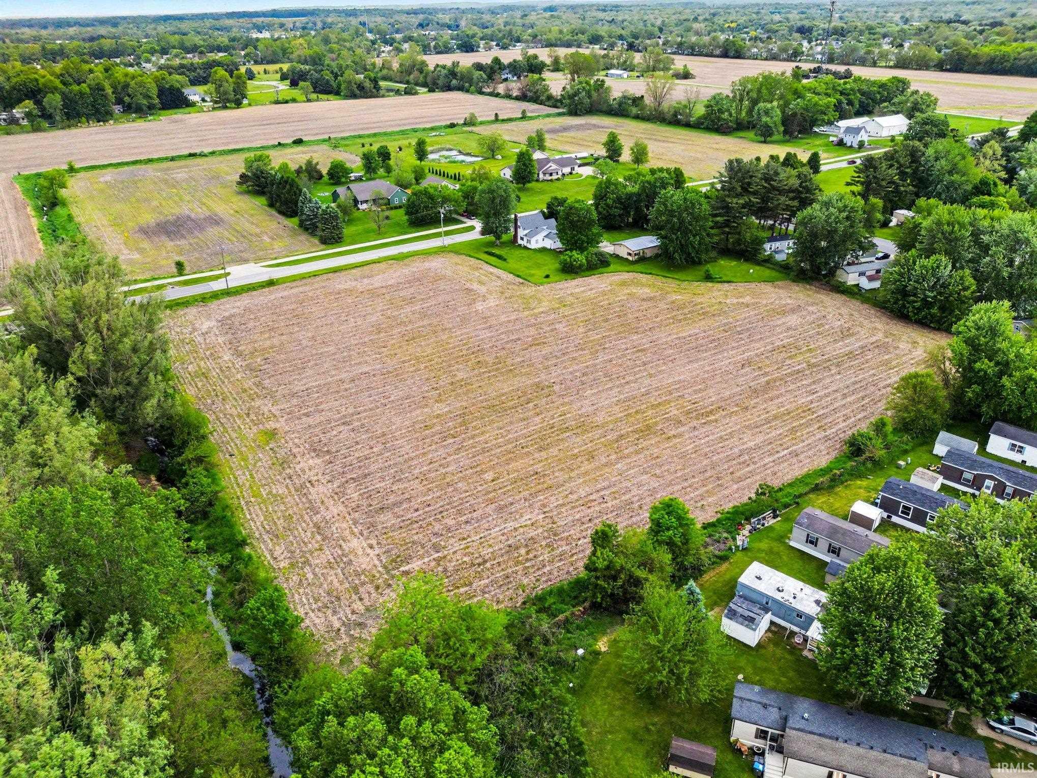 Expansive land parcel featuring cultivated fields and abundant green space