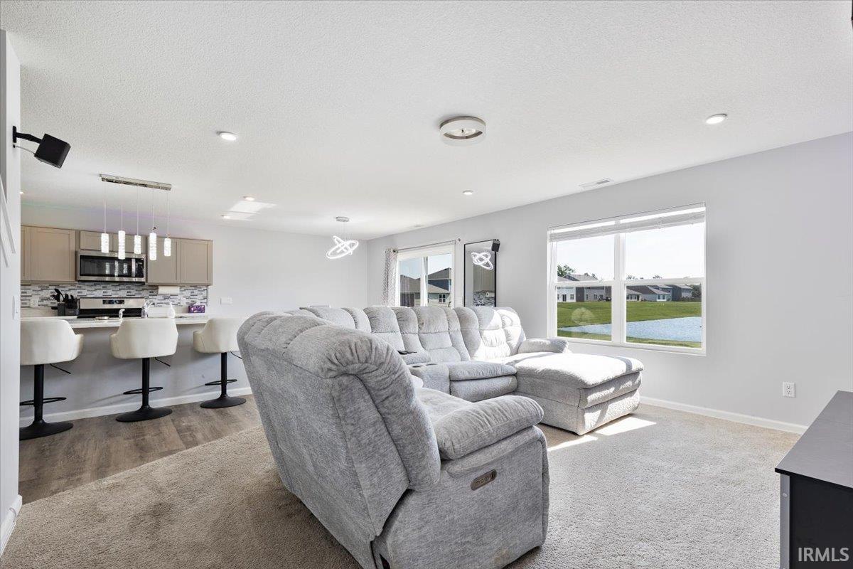Open-concept living space featuring recessed lighting and a large picture window