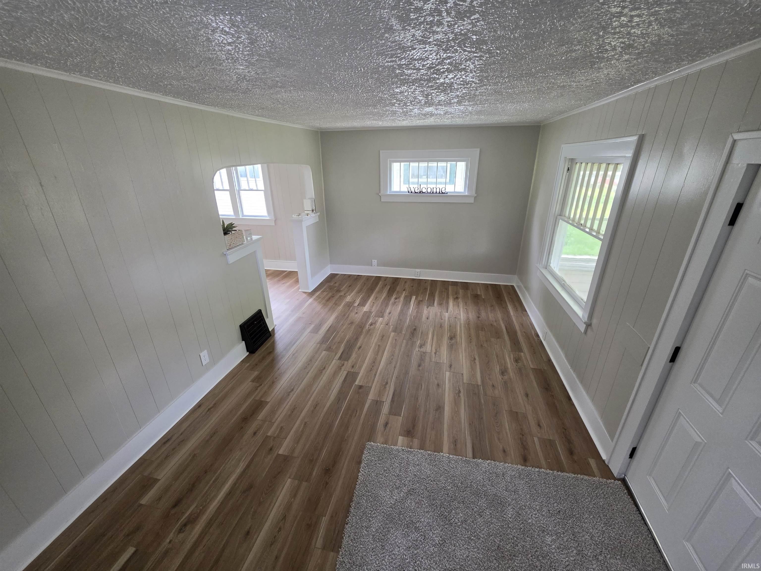 Wood-finish flooring throughout, complemented by white baseboards and trim