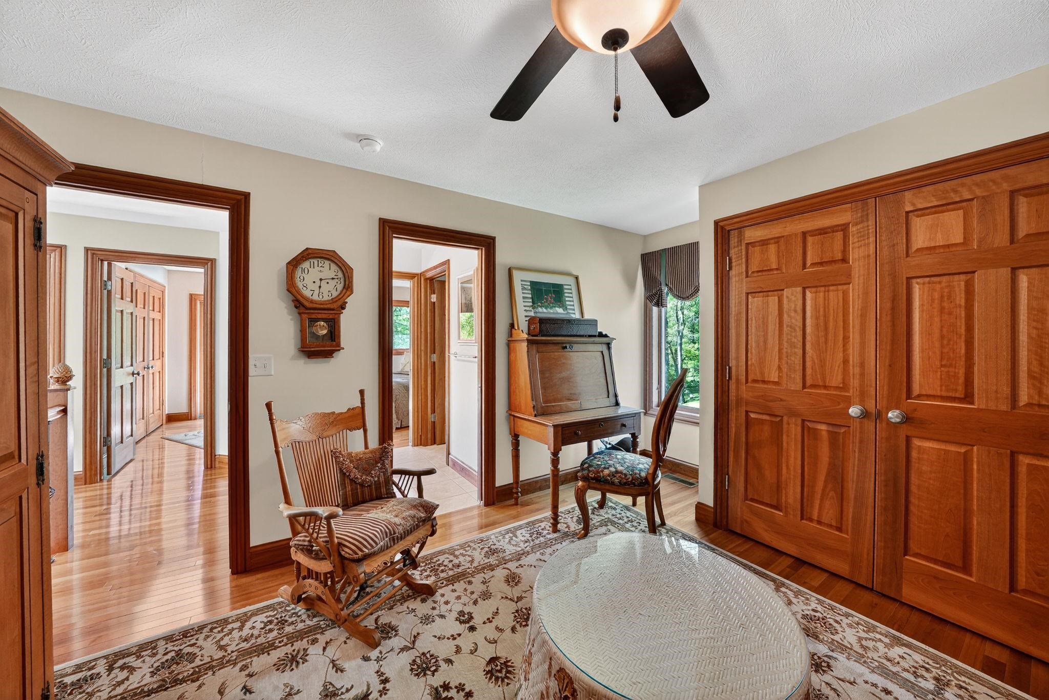 Warm wood flooring throughout, complemented by matching wood trim and panel doors