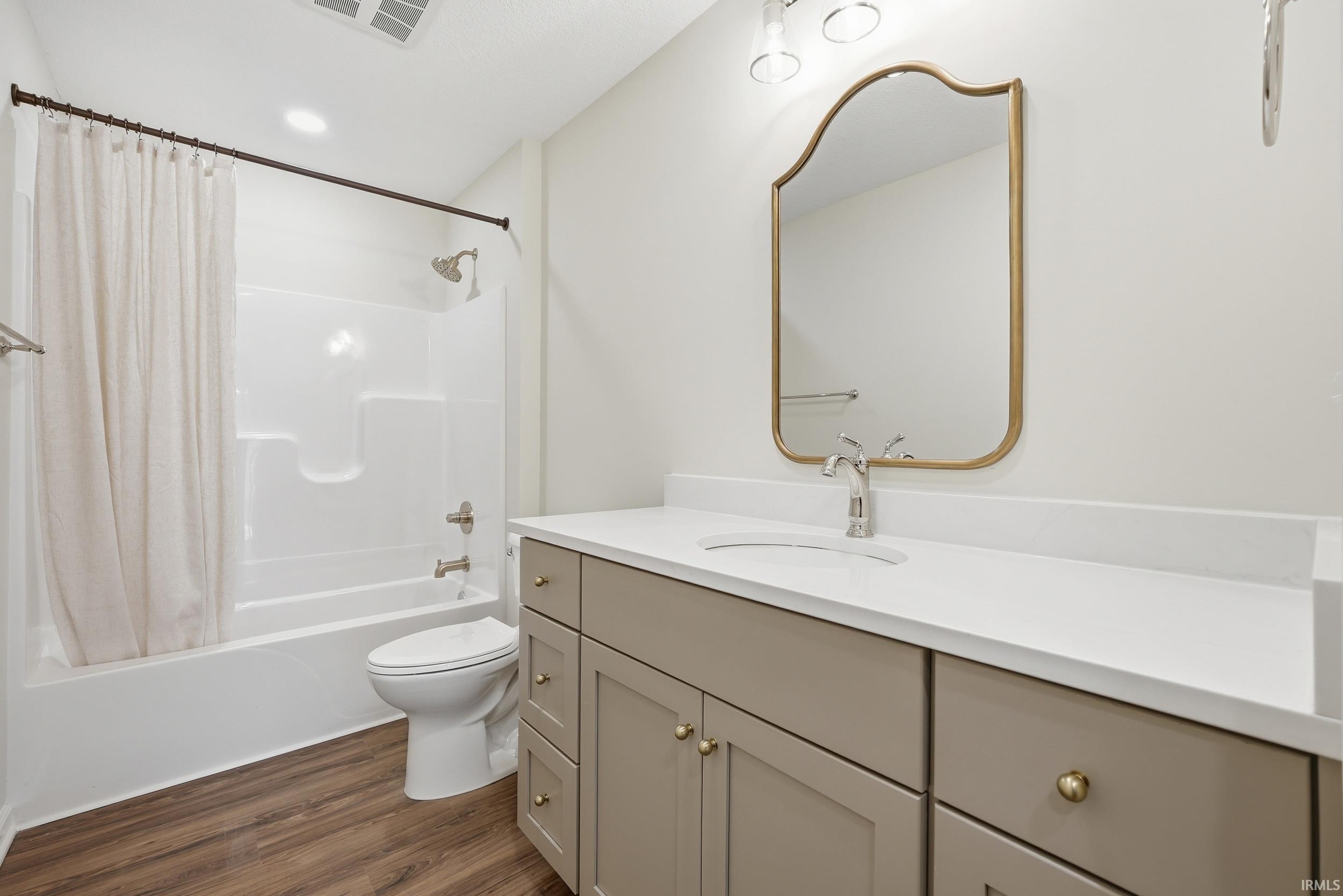 Bathroom featuring a single vanity with a white countertop, under-mount sink, and contemporary faucet