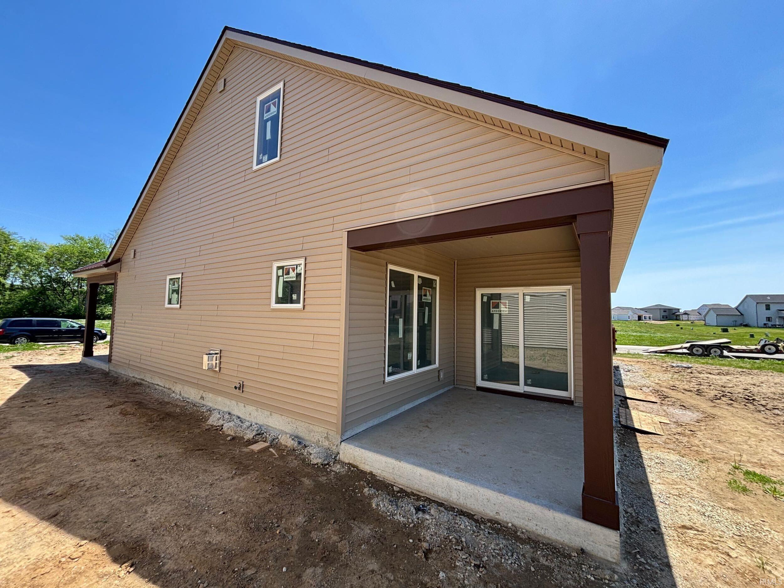 Exterior with tan horizontal siding