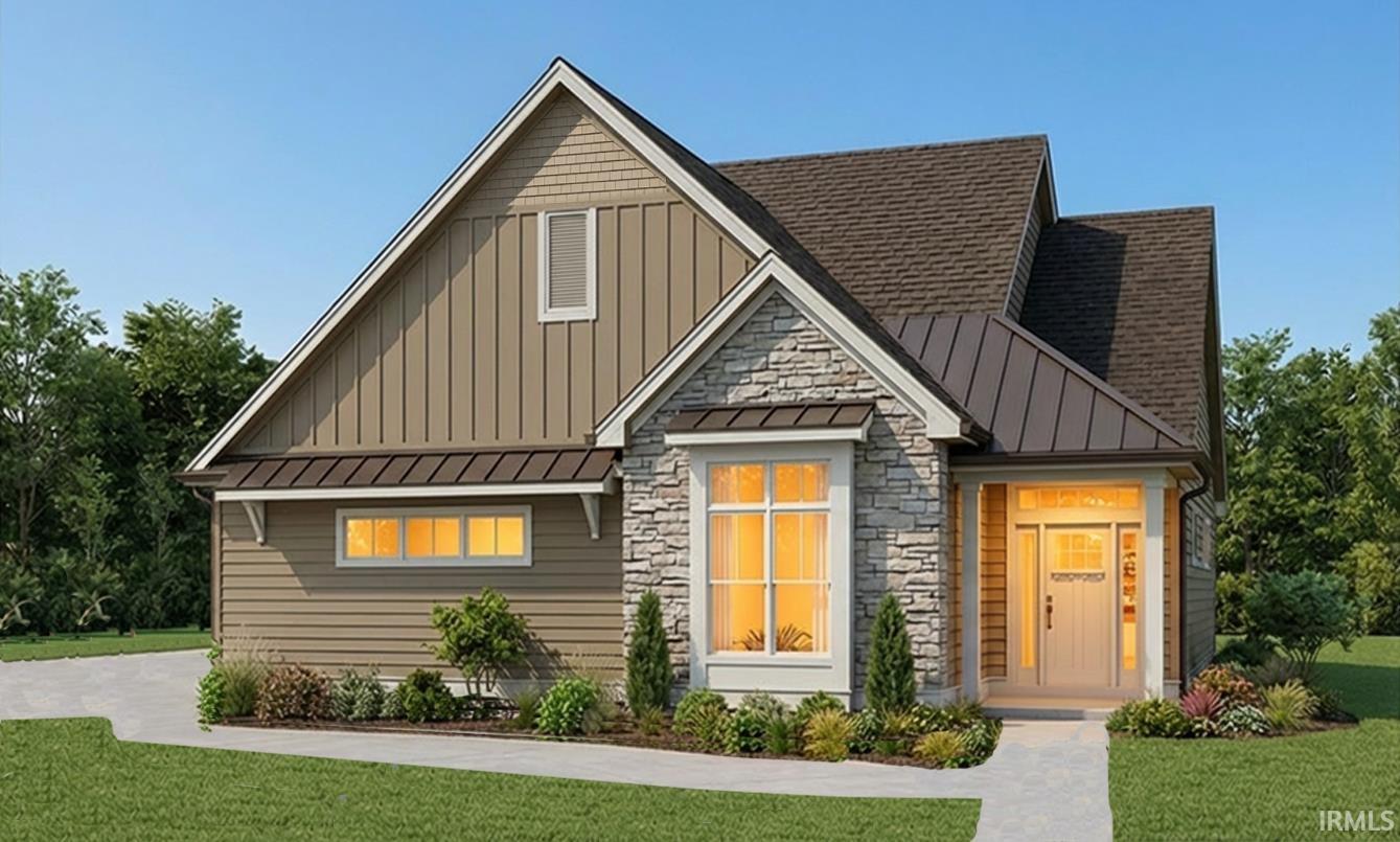 View of front of house with a standing seam roof, a front yard, and board and batten siding