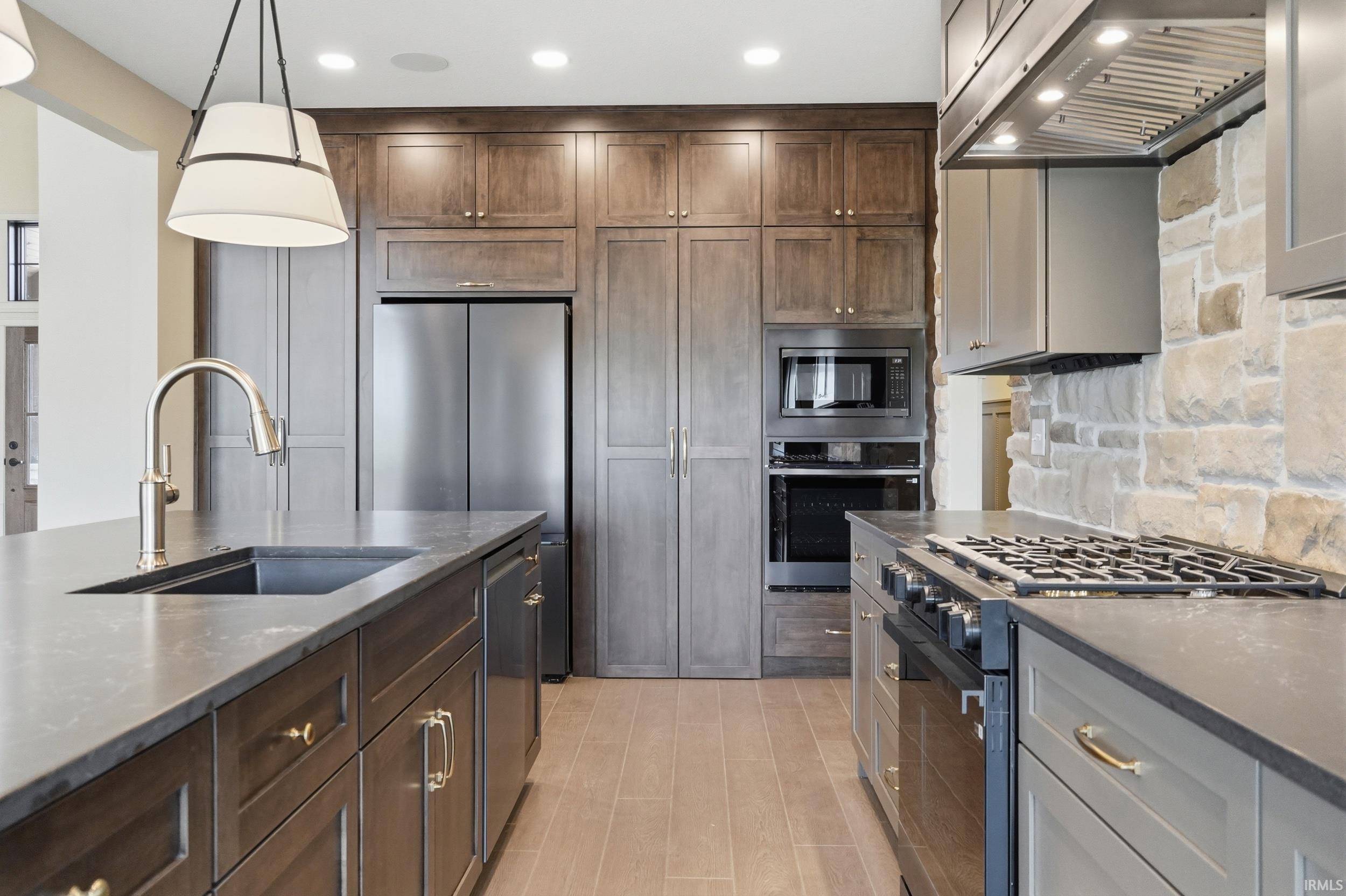 Gourmet kitchen featuring a built-in stainless steel refrigerator, microwave, and oven