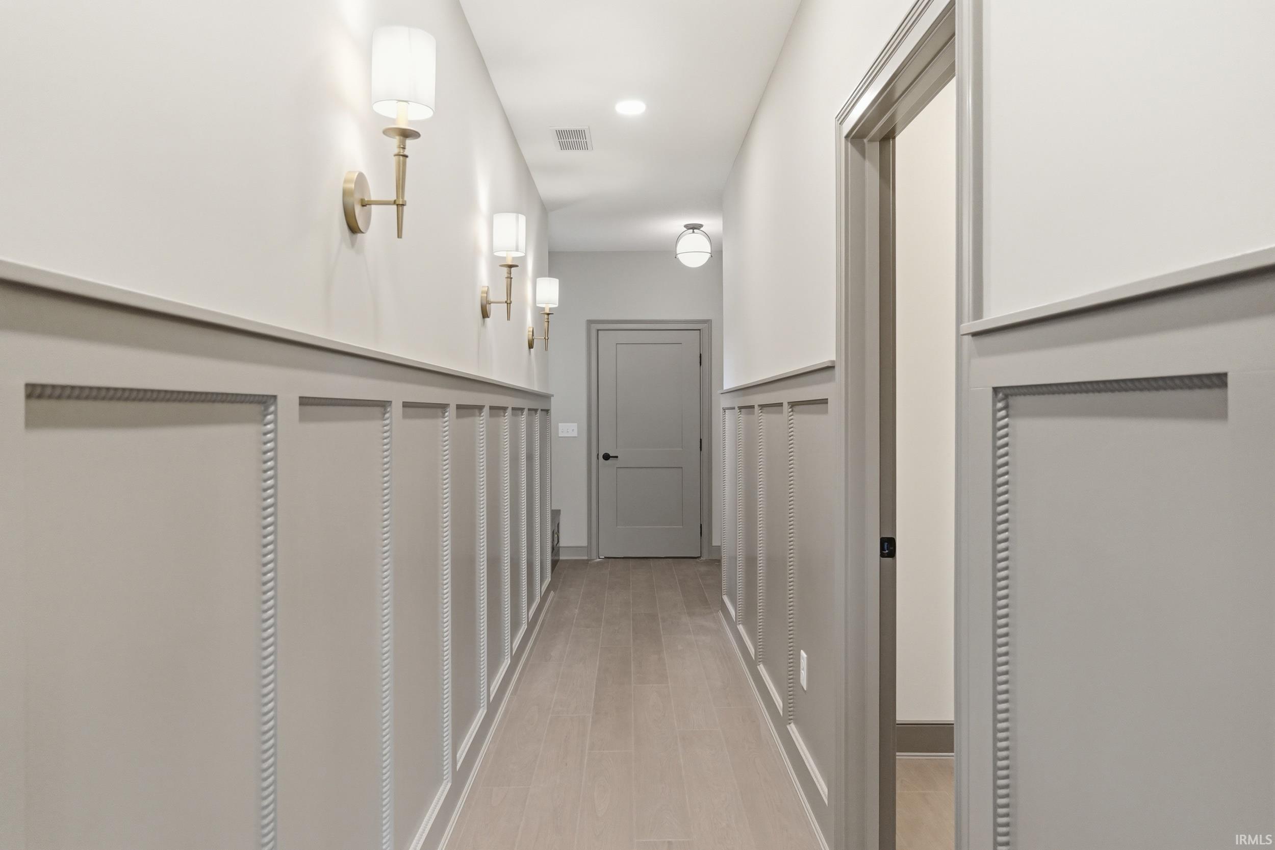 Hallway featuring wainscoting with decorative rope molding, recessed lighting, and wood-finish flooring